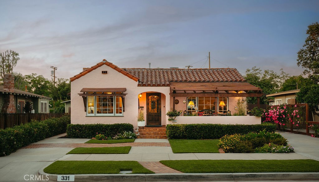 A Rare Spanish Colonial Revival Gem in Fullerton’s Historic Core.
Step into a piece of Fullerton’s architectural legacy with this enchanting Spanish Colonial Revival residence - a home carefully curated to reflect the elegance and design integrity of the 1930s. Included in the 1978 Fullerton Historic Survey and celebrated among the city's most architecturally significant homes, this timeless treasure seamlessly blends preserved vintage character with refined modern enhancements.
Thoughtfully designed across approx. 1,490 sq ft, the home offers 3 bedrooms and 1 bath, with hallmark period details including arched entryways, coved ceilings, wood-framed French pane windows, and original hardwood floors that echo the craftsmanship of a bygone era. Anchoring the living room is a fully restored Batchelder fireplace - a true work of art and a rare architectural centerpiece.
The kitchen features a vintage O’Keefe & Merritt range, perfectly complementing the home’s historic soul. Thoughtful interior touches, including custom Roman shades and draperies, enhance the home’s warmth while maintaining its timeless character. The third bedroom enjoys its own private entrance, offering flexibility for guests, a home office, or creative studio space.
Outside, a serene and private backyard offers the ideal setting for alfresco dining or quiet retreat, all nestled on a 5,432 sq ft lot along one of Fullerton’s most beloved tree-lined streets, just moments from the vibrant downtown district. The property also offers rare parking capacity for up to five vehicles, including a garage and additional driveway, ensuring convenience in a highly walkable neighborhood.