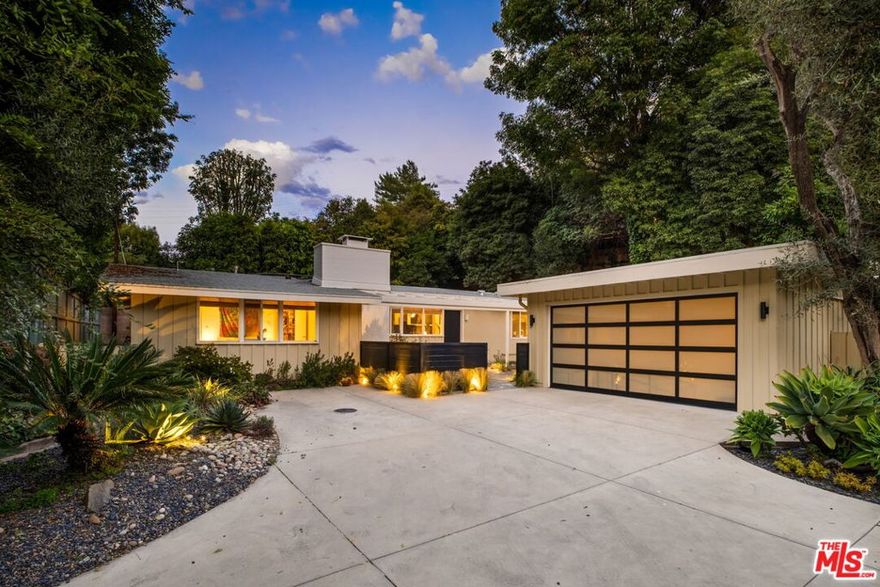 Set in one of Brentwood's most tranquil canyons, this home feels both architecturally significant and deeply serene - a true retreat just moments from the city. Tucked into peaceful Upper Mandeville Canyon, this is a mid-century modern gem set in a very private and protected property. The 3 bedroom, 2 bath home reflects the timeless essence of architectural Cali living with clean lines, natural light, and an easy connection between indoors and out. Designed as a Mid-Century modern by renowned LA architect Allen Siple, the open layout unites the living, dining, and kitchen areas, where walls of glass fill the space with sunlight and frame views of private, lush greenery. The kitchen was recently reimagined with warm oak cabinetry, Zellige tile, brass fixtures, and sleek quartz counters that blend modern design with mid-century character. Open shelving displays curated ceramics, and a large window looks out over the courtyard. The primary suite opens to a private backyard sanctuary with a pool, fountain, and plenty of lounge space for relaxing or entertaining. A bonus and detached 800-square-foot garage and creative studio offer endless possibilities for work or play.