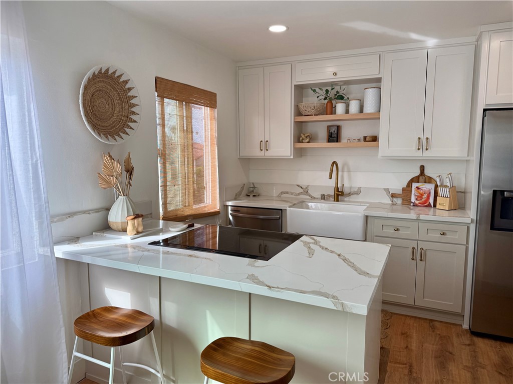 Live the island lifestyle in this fully furnished 1-bedroom, 1-bath condo located in the heart of Naples Island, one of Long Beach’s most desirable waterfront communities. Just steps from the scenic canals, sandy beaches, and the vibrant energy of 2nd Street, this light-filled unit offers the perfect blend of coastal tranquility and urban convenience. Inside, you’ll find an open-concept living and dining area bathed in natural light, a modern kitchen with stainless steel appliances and granite countertops, and a spacious bedroom with ample closet space. The sleek bathroom features contemporary finishes, while hardwood floors run throughout the unit, adding warmth and style. Enjoy your morning coffee or unwind in the evening on your private balcony. The condo comes fully furnished with tasteful, comfortable pieces—just bring your suitcase and settle in. The secure building offers gated entry and includes an assigned parking space. With easy access to Alamitos Bay, Mother’s Beach, bike paths, and paddleboarding, plus a quick commute to downtown Long Beach and major freeways, this condo is ideally situated for both relaxation and adventure.