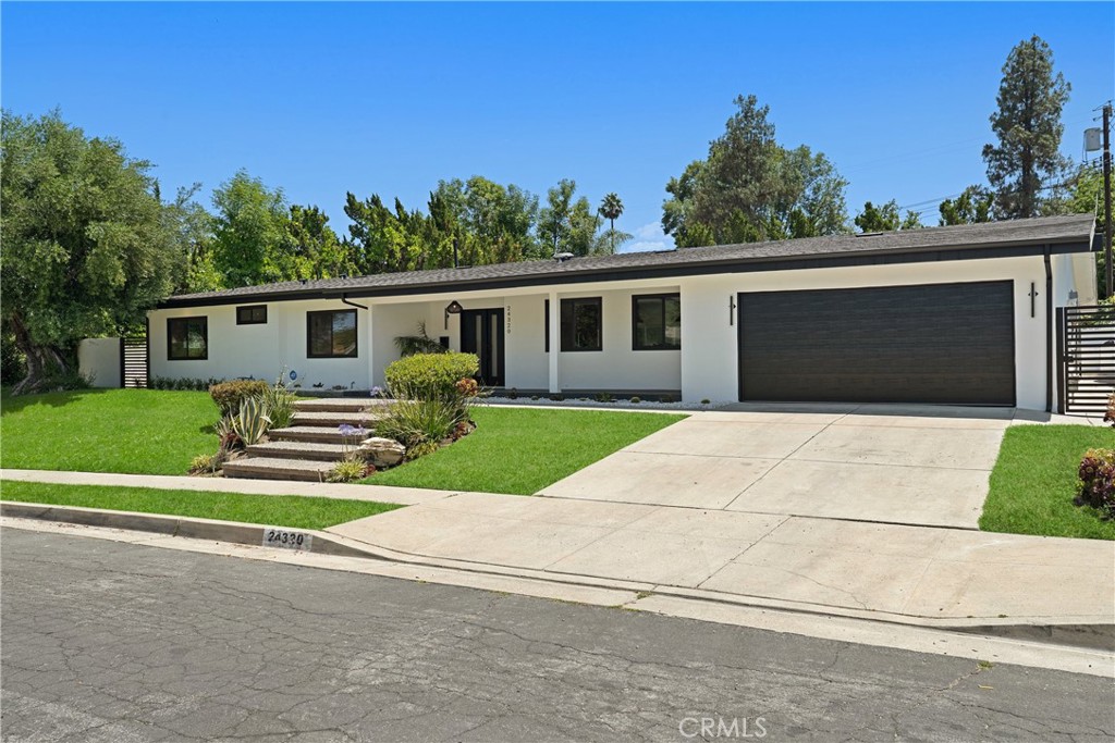 Welcome to a masterfully reimagined single-story estate, nestled on a peaceful cul-de-sac in the heart of Woodland Hills. This fully remodeled 5-bedroom, 4.5-bathroom home blends timeless design with thoughtful modern touches, crafted to elevate everyday living.
Step inside to an airy open floor plan featuring vaulted ceilings with exposed wood beams, wide-plank European oak floors, and expansive sliding glass doors that open to a lush, resort-style backyard. The seamless indoor-outdoor flow creates the perfect setting for both relaxed living and effortless entertaining.
At the heart of the home, the designer kitchen is stunning, featuring quartzite countertops, custom cabinetry, an oversized island, and top-of-the-line stainless steel appliances—equal parts elegant and functional.
Retreat to the luxurious primary suite, a true sanctuary boasting two separate walk-in closets, a spa-inspired bathroom with a standing shower and freestanding soaking tub, and beautifully curated finishes throughout.
On the opposite side of the home, discover a spacious fifth bedroom, offering ideal separation for guests, a private office, a gym, a game room, or multigenerational living.
Step outside to your own private oasis: a tranquil waterfall cascades into a peaceful pond, framed by mature landscaping, lounge areas, and a built-in grill—ideal for entertaining or quiet moments of escape.
Every corner of this home has been thoughtfully curated with sophistication, comfort, and lifestyle in mind. A rare offering in a prime Woodland Hills location.