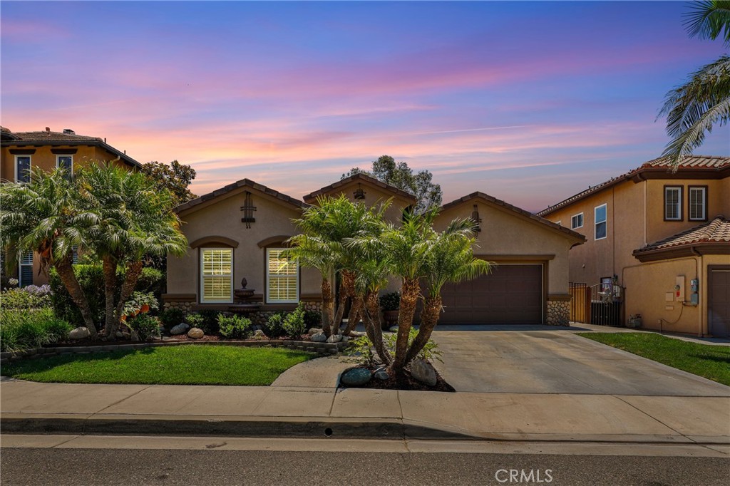 Discover this beautifully upgraded single-story home with sweeping views of city lights and surrounding hills, located in the highly desirable Serrano Heights community. This immaculate 3-bedroom, 2-bath residence blends modern luxury with timeless elegance—perfect for today’s discerning buyer. Enter through a grand entryway and spacious enclosed front courtyard into a formal living and dining area with built-in China hutch designed for effortless entertaining. The expansive family room, centered around an elegant tiled fireplace, creates a warm and inviting space ideal for relaxing or casual gatherings. The upgraded gourmet kitchen boasts sleek granite countertops, abundant cabinetry, stainless steel Kitchen Aid appliances, a center island and a charming breakfast nook. The spacious primary suite offers a peaceful retreat, complete with a walk-in closet and a beautifully remodeled en-suite bath featuring dual vanities, a soaking tub, and a walk-in shower—combining comfort and style in every detail. Enjoy outdoor living in the expansive backyard, Where you’ll enjoy peaceful views of rolling hills and the distant city skyline.—perfect for entertaining or unwinding at the end of the day. Additional features include a two-car garage, efficient whole-home ventilation system, water softener, a convenient indoor laundry room and recent upgrades that make this home truly move-in ready—including gorgeous new flooring and updated baseboards throughout (excluding the formal living room). Located near top-rated schools, scenic parks and trails, shopping and dining, this pristine home offers unmatched comfort and convenience—all with low HOA dues. Don’t miss your chance to own this exceptional single-level home—schedule your private showing today!