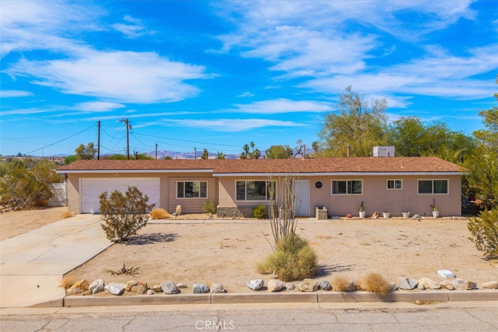 Located in one of the most desirable neighborhoods of 29 Palms, this fully turnkey 3 bedroom, 2-bathroom home offers comfort, charm, and unbeatable proximity to the east entrance of Joshua Tree National Park. Step inside to discover a light filled interior with a spacious bonus room perfect for a home office, studio, or guest retreat with a soaring, beautifully crafted wood ceiling that adds warmth and architectural character to the space. Enjoy sweeping desert views and serene sunsets from the private fenced yard, with plenty of space to relax or entertain. This home is move in ready and perfectly positioned for nature lovers, short term rental investors, or full time residents seeking peaceful living with modern convenience.
Capitalize on this opportunity to own a piece of the high desert where everything is within minutes whether it's hiking, climbing, and the vibrant local art and music scene of 29 Palms, or yummy bites to eat at the 29 Palms Inn Restaurant, Kitchen in the Desert, Snake Bite 29 Palms, and more!