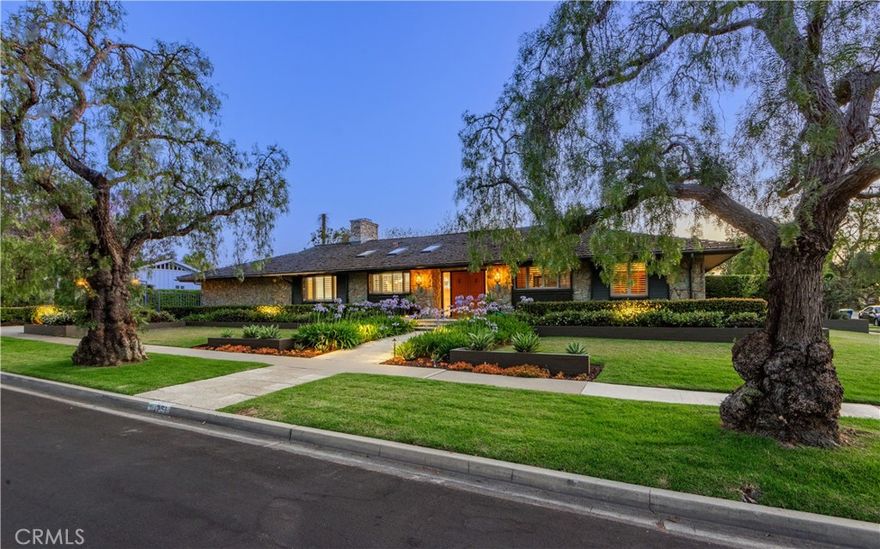 Located within the sought after neighborhood of Park Estates, 1251 Bryant Road is a sprawling single-level mid-century modern ranch style home sited on a large 10,375 SF lot. Designed by architect Raymond A. Sites, this fine estate home is a testament to his visionary approach to architecture. Positioned on a prime, interior corner lot, this custom residence boasts exceptional curb appeal with expansive and beautifully landscaped grounds. The sprawling U-shaped residence features a thoughtful and spacious floorplan with 3 bedrooms (potential 4 bedroom) plus a home office, 3 bathrooms, and 3,072 sq. ft. of living space. The home’s striking design, Palo Verde stone façade, mahogany doors and accents, and oak flooring provide a warm, timeless appeal. Expansive 30-foot great room with beamed ceilings and generous use of windows and sliders is at the center of the home. Gourmet kitchen is equipped with high-end appliances, an extra-large island, casual eat-in dining area, workstation, and is open to the Great Room. Separate family room/game room with gorgeous beamed ceilings and stand behind bar area with space for a potential fourth bedroom. Primary en suite offers a private retreat with fireplace, updated bathroom, and two walk- in closets. The additional two bedrooms located on the opposite wing are spacious with upgraded hall bathroom. There is a wonderful indoor laundry room as well as a separate mud room. The Napa inspired backyard is equally impressive featuring a beautiful patio with thoughtful lighting, stone planters, and an outdoor kitchen. Covered patio/loggia space, fireplace, spa, and water wall feature providing an organic and peaceful feel. The large lot offers tons of space for enjoying the outdoors with grassy areas and mature trees that add privacy and beauty. There is an elegant electronic gated driveway leading to garage complete with fresh paint and new epoxy flooring. Living in Park Estates the residents enjoy the beautiful tree-lined streets, wide lots, and tight-knit community. Minutes from Alamitos Bay, this residence is ideally situated to enjoy the best of both worlds: neighborhood living with convenient access to the nearby beaches. Top-rated schools, golf courses, and local parks. Nearby Alamitos Bay offers watersports, kids camps, SUP, boating & sailing. Centrally located to LA, South Bay, & Orange County. 1251 Bryant Road is a rare opportunity to own a fine architectural home in one of the area's most sought-after communities.