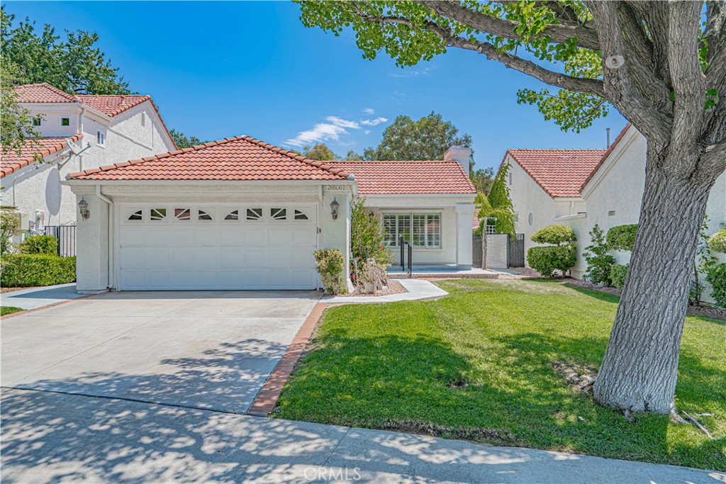 Say hello to this beautifully updated single-story home in the highly sought-after Valencia Summit - one of Santa Clarita’s premier communities. Situated on a quiet cul-de-sac, this 2-bedroom, 2-bath property offers a thoughtfully refreshed interior, including a recently updated kitchen with modern finishes, and new flooring. The primary suite has its own private bathroom, while the second bedroom includes a Murphy bed for space-saving and added flexibility. Both bedrooms offer spacious walk-in closets. Step outside to enjoy a sitting area as well as a private and spacious backyard with an elevated area for a hot tub overlooking a tranquil belt of lush woods and greenery. For even more outdoor enjoyment, walking trails, parks, and Summit’s renowned amenities including the sparkling association pool are all nearby and waiting for you. Finally, the attached two-car garage offers plenty of storage all around, and space above for more. Conveniently located near Valencia Town Center, College of the Canyons, Cal Arts, Henry Mayo Hospital, and top-rated golf courses. With quick access to the 5 freeway, this home blends quiet neighborhood living with city convenience. This is a truly rare opportunity in one of the most desirable pockets of Santa Clarita. Call and schedule your private showing today.