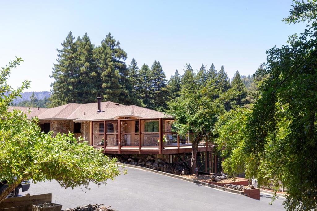 LEGACY PROPERTY! The House On The Hill. A rare opportunity to own your private paradise. This beautifully maintained 7 acre estate features a picturesque heart-shaped pond and rolling meadows teeming with wildlife-truly a bird watcher's dream with frequent visits from deer, flocks of turkeys and more. The charming ranch-style home offers generous living space with large bedrooms and two cozy wood-burning stoves. Enjoy a relaxing soak in the sunken bathtub or work peacefully in a bright office with serene views of the meadow. Spacious kitchen and dining area perfect for entertaining, complete with large windows overlooking the private deck and landscape. Over sized garage provides ample workspace, plus room for RV parking & heavy equipment. Outdoors you will find mature fruit trees, a fenced yard with adorable goat house. Access the property via a long driveway with private electric gate. This is more than a home..IT IS A TREASURE!
