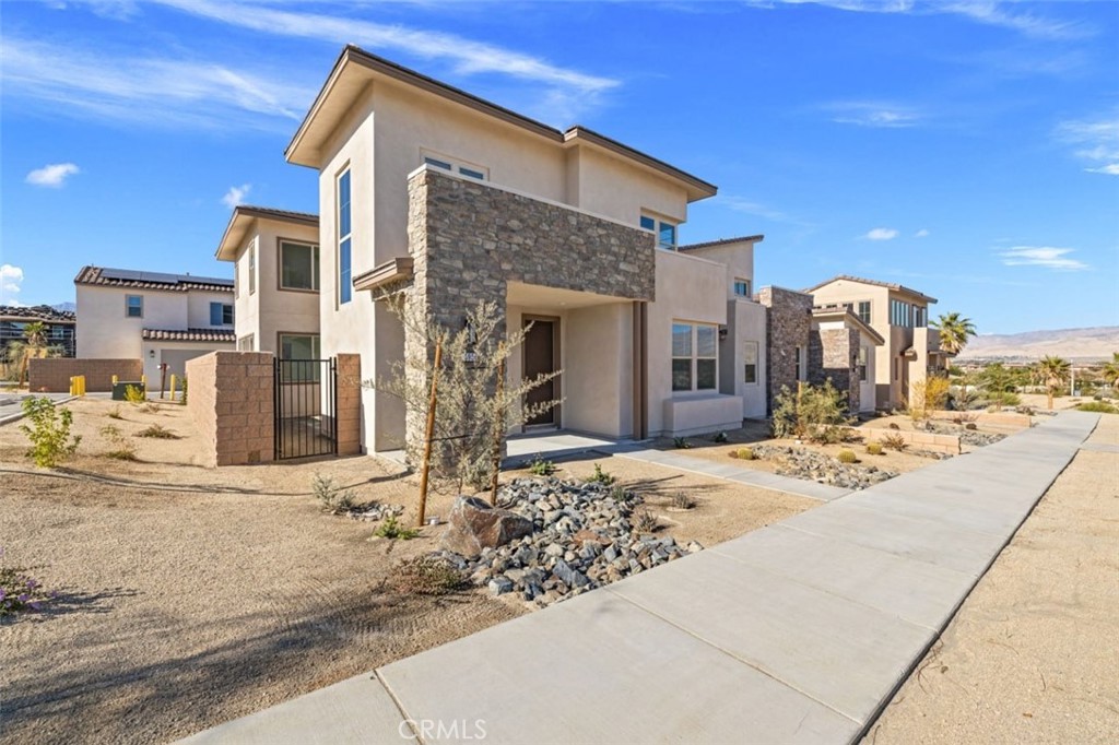 Price Reduced to Rent!!! Discover this recently built, solar-powered 4-bedroom, 3-bath home on a premium corner lot in Palm Desert's highly sought-after University Park community. Featuring a bright open floor plan with elegant tile flooring, a gourmet kitchen with stainless steel appliances, and a private first-floor casita with separate entrance ideal for guests or multi-generational living. The spacious primary suite offers a spa-inspired bath with dual vanities, soaking tub, glass shower, and a large walk-in closet. Enjoy unobstructed mountain views from your private patio, with no neighbors on two sides for added privacy. The backyard is beautifully illuminated with lights, creating a perfect setting for evening gatherings an upgrade rarely found in the neighborhood. The finished two-car garage includes an EV charging station and energy-efficient tankless water heater.
Residents of University Park benefit from resort-style amenities including multiple pools, a modern clubhouse, fitness center, pickleball and bocce courts, playgrounds, BBQ areas, and expansive green spaces. Conveniently located near top-rated schools, El Paseo shopping and dining, parks, hiking trails, and easy freeway access. Landlord does not live on-site. Small pets allowed.