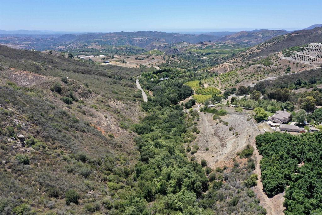 Welcome to the prestigious De Luz Community—an exclusive sanctuary for your dream estate, where serenity, refined living, and the beauty of nature come together. Just 20 minutes from Temecula, this remarkable nearly 10-acre parcel offers endless potential and a rare opportunity to secure one of the area’s most desirable properties. A gently graded flat acre provides the perfect canvas for your future home, whether a contemporary architectural masterpiece, a serene ranch-style retreat, or an equestrian estate. Nestled beside the 9,000-acre Santa Rosa Plateau Ecological Reserve, you’ll be surrounded by sweeping mountain views, a seasonal creek, and vibrant natural surroundings. Nearby, multi-million-dollar estates set the tone for the community. This property includes over $53,000 in water rights (one-time fee paid), up to a 2” water connection, electrical access at the frontage, and paved road access. Minutes from CrossCreek Golf Club, designed by Arthur Hills, it offers both seclusion and lasting value.