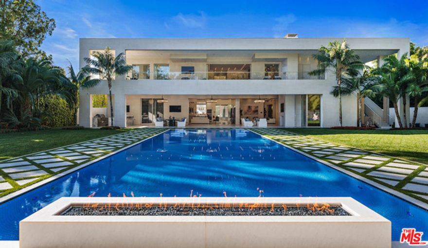 Private and gated contemporary estate in one of the best locations in the world behind the Beverly Hills Hotel w/ no alley behind the property.  7 bedrooms, 11 baths and approximately 20,800 sq. ft. under roof, including a large cabana, covered upper & lower living room loggias & garage (Approx 14,250 sq. ft. air-conditioned). 4 suites up including master, all w/ covered balconies & 3 large guest suites . Enter thru the dramatic foyer of high ceilings to a hotel-style huge fully tiled saltwater in ground infinity pool, large yard and one of the most spectacular water features ever built in BH spanning long of computerized waterfall & light show. Approx. 3,200 sq ft luxurious master wing w/ 3 fireplaces, cabana-style outdoor living area w/ a masonry fireplace. Sumptuous her bath suite w/ a private balcony framing a picture perfect city view. His bath suite w/ equal grandeur and style without compromise. Exquisite movie theater w/ adjoining game room and parking for 20 cars.