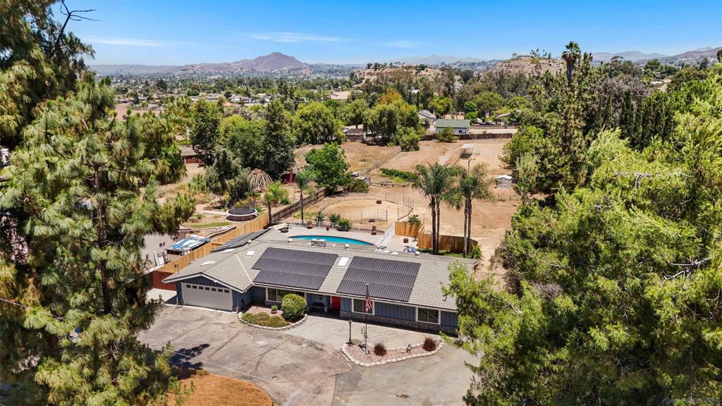 Fall in love! Seller open to help buyer with buying down rate, or closing costs to help the right lucky buyer with the right offer. Single story horse ranch home in Granite Hills on 1.20 acres of level land which offers privacy and serenity which is why the owner loved living here for 10 years. This is truly a place to call home and has so much to offer. Lets start with the ability to own horses while still being 5 minutes to all the amenities of city living! Large 4 bedroom home. All bedrooms are a good size and one is located at the other end of home, great for separate office or to use as a family room. Direct access to the large sunroom adjacent the sparkling pool. Roof has a bountiful 38 paid for solar panels installed by Baker Electric! EV charging port installed. Home was just painted inside and out. New beautiful fireplace surround. Tile and Hardwood floors. Current owner had 5 horses, and a pig. The mornings and afternoons are delightful here. The sunroom, pool, separate deck area with fire pit, and spa, allows for many people and is an entertainers delight. Access to back of property from right side of home and great space for RV parking. This is the home you can retire in. So much land and so many possibilities. Create your own resort or utilize the space for work needs. Possible VA assumption by a veteran but buyer would need a very large down payment. Septic has just been pumped, updated repairs completed and system certified.