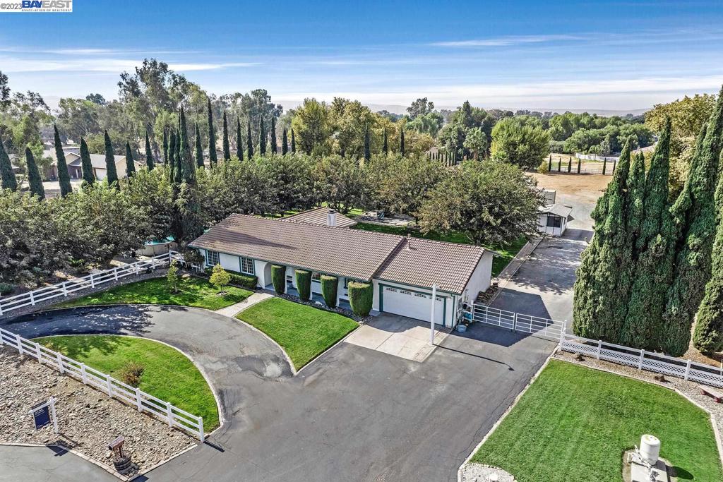 Location, Lot and Layout! The THREE most important things in real estate. Yes, these things you can't change. And be glad because the Masson Ranch exemplifies the best of all of it! Not a thing to change with this spectacular ranch estate. Few and far between do you find a home where the house and the land are both spectacular! The kitchen is stunning with it's custom cabinets, granite counters and stainless appliances. Large center island work space and a great breakfast bar counter. Formal dining and living and the coveted open kitchen/family room combo. Large primary suite with luxurious bath and walk-in closet. Spacious secondary bedrooms and a grand hall bath. HUGE attached 2-car garage (extra deep). The property is extraordinary; 11 Mulberry trees canopy the lush lawns in the backyard. Barn, shop, shed and boat storage. Pool and vegetable/flower garden. HUGE paved side access and of course about 3/4 acres of blank slate to do what you want. Horses, vineyard, orchard, golf course! you name it! Now, the best part: On a quiet dead end st with orchards out the front, tranquility and privacy all around. On the NW side of Tracy, commute close to I580 and super close to the new shopping centers on the North side. Truly an exceptional property. Live Well!