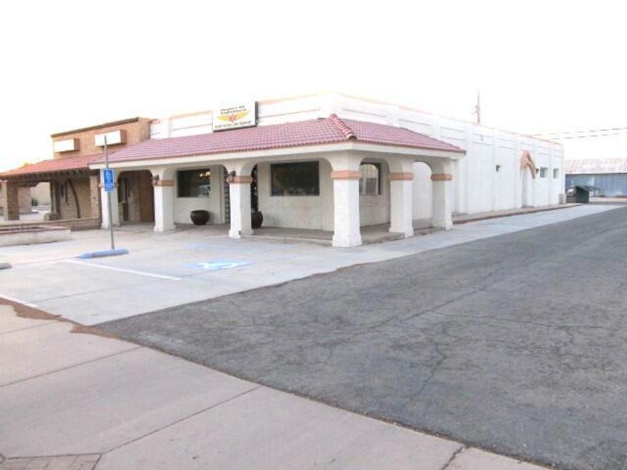 121 E. Hobson Way. Approximately 3060 Sq ft of Building Space.  Yes! Right in the Very Heart of the City of Blythe.  Approximately 50 ft of frontage off of E. Hobson Way between N. Broadway and 1st Street.  All Paved Parking (17) Spaces. Allies are Paved. Plenty of Office Space plus 2 Private Offices, all carpeted. There is a Side Room on the NE Side of the Building at the front of the building that is the wiring room and also leads to a section where there is storage space for several private file cabinets that could be locked.  At the very back of the building is a spacious tiled Kitchen area with Cabinets, Counter Tops, Refrigerator and Electric Stove and a Sink. Lots of Room for a Table and Some Chairs.  The Building includes 2 Restrooms, one to accommodate handicapped. Two a/c units one 5 ton and one 6 ton a/c unit. To be sold with additional APN 845-151-008.
