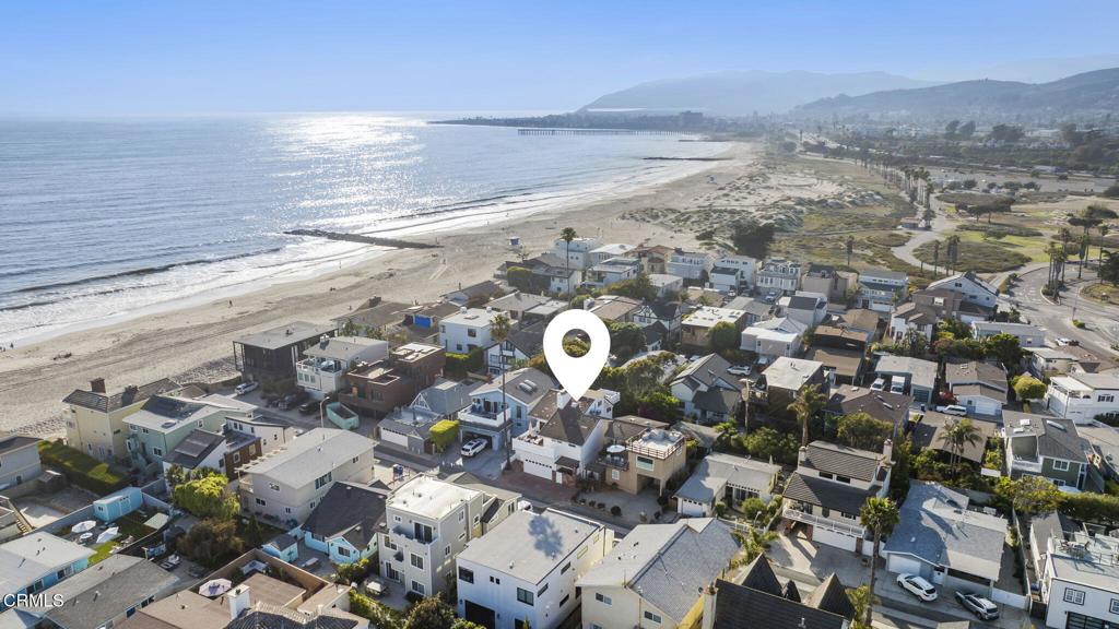 Permanent Ocean Views & Steps to the Sand - Your Pierpont Beach Dream Home Awaits!Welcome to true beachside living in this beautifully appointed Pierpont retreat, just six lots from the sand and only two lanes from the scenic boardwalk--perfect for bike rides or sunset strolls to the Ventura Pier and Downtown.Enjoy stunning, permanent ocean and island views from your own living room, while cool breezes and the sound of crashing waves complete the ultimate coastal experience. With over 2,500 square feet of living space, this versatile home offers 4 bedrooms, 3 full bathrooms, two expansive viewing decks, and a large backyard--perfect for entertaining or relaxing after a day at the beach.The main level welcomes you with a cozy living area featuring a fireplace, two bedrooms including a spacious primary suite with full bath, and access to a private backyard with charming brick patio--ideal for BBQs, gardening, or outdoor gatherings.Upstairs, original hardwood floors and vaulted exposed ceilings are filled with natural light. The open-concept living and dining areas are designed to take full advantage of the sweeping ocean views and open onto a generous viewing deck. The updated kitchen features granite countertops, a large center island, stainless steel appliances, and a walk-in pantry. A third bedroom with ensuite bath and an additional full guest bathroom complete the second floor.On the third level, you'll find a flexible fourth bedroom or perfect work-from-home office, featuring a large walk-in closet and a private balcony with views of the Ventura hills.Situated near local favorites including restaurants, coffee shops, shopping, and convenient freeway access, this home is ideal as a full-time residence, weekend getaway, or high-demand investment opportunity.Don't miss your chance to live the Pierpont lifestyle!
