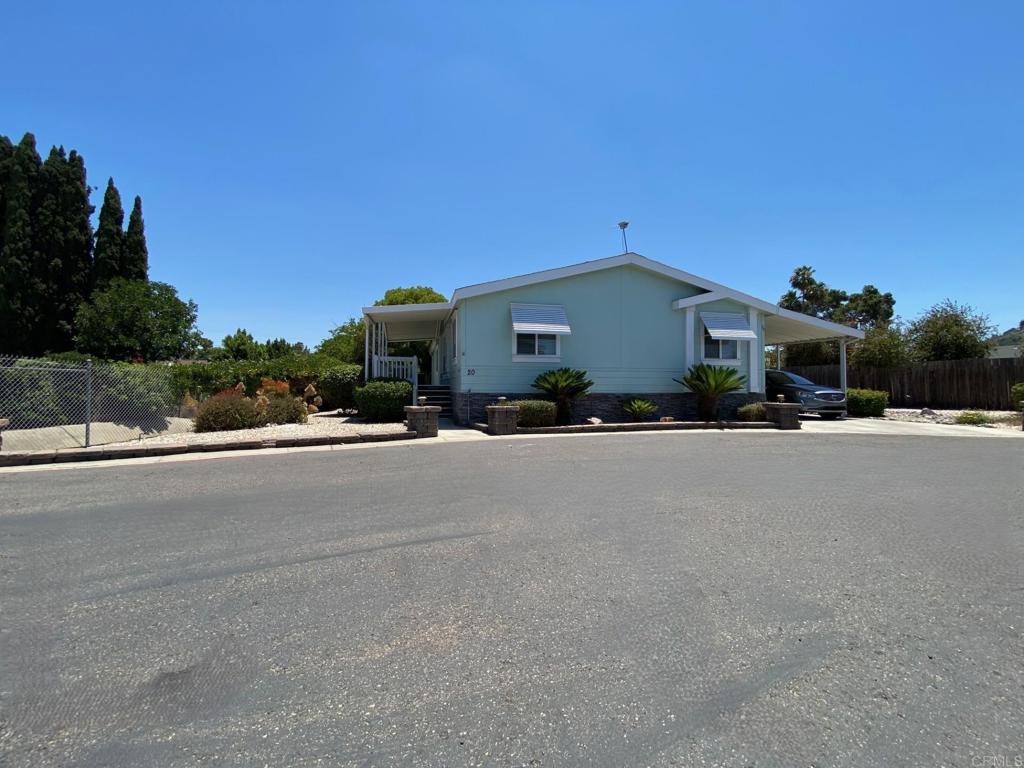 This luxurious 2006 manufactured home is like no other! Amazing 1754sf home in move-in ready condition and on an amazing location within this 55/18 community. The sellers just added new luxury vinyl plank flooring in the living room, dining room, hall and bedrooms; the interior of this beautiful home was just painted, and new faucets were added to the kitchen and the bathrooms. Highly desirable split floor plan with the main suite at one end of the home, while the additional bedrooms and 2nd bathroom are at the opposite end. The incredible oversized main suite has a large retreat room; this room would make the perfect home office, reading quarters, hobby room, or anything else you may wish to use it for. There is also a large walk-in closet and an ensuite bathroom with dual sinks and a walk-in shower stall. The gourmet kitchen offers ample cabinetry and counter space; in addition, there is an island with a sink and lots of storage within. Breakfast bar and stainless steel appliance package. Refrigerator, microwave over the range, dishwasher and refrigerator. Cabinet over the bar has beautiful glass doors. Dining and breakfast areas, plus a very large living room, custom front door with beveled glass. Spacious bedrooms and guest bathroom. Dual pane windows, drywall throughout, central heat and air conditioner. Indoor laundry room with shelving, washer/dyer included. The large carport easily accommodates three vehicles. Enjoy your morning coffee or afternoon tea on your own covered deck. 10'x12' custom storage shed. This is one of the most amazing lots I have seen in a mobile home community; it gives the sense of seclusion and peacefulness at the same time. It's very private and spacious lot; fenced on 3 sides, surrounded by beautiful landscape and mature trees. This spectacular home offers everything you need to live comfortably and in luxury. You will be proud to entertain family and friends in this jewel of a home! Call today to schedule your viewing appointment before this home is gone. LBJ4587.