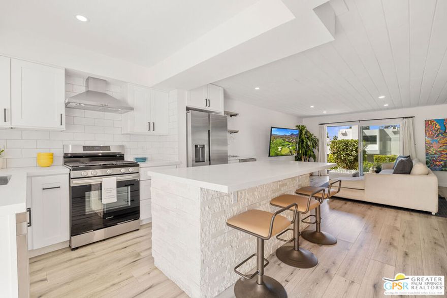 Perfectly Positioned, Updated, and Move-In Ready! This light-filled two-story townhome offers modern style, effortless indoor-outdoor living, and stunning mountain and pool views. Perched just right above the pool, it strikes the ideal balance of privacy and connection with a private path to the pool! The open-concept main level showcases a reimagined kitchen with an oversized island, designer finishes, and seamless flow into the living and dining areas. A gated front courtyard with a fun pass-through to the kitchen adds charm and functionality. Also on the main level are a powder bath and large under-stair storage closet. Upstairs, the updated primary suite features a modern bath and a ceiling-mounted TV that retracts when not in use. A newer laundry area adds convenience to the second level. The guest bedroom, currently used as an office, is located at the opposite end and includes a fully updated bath, offering ideal bedroom separation. Additional highlights include two assigned covered carports, a rare feature in the 120-home Mountainback community. Amenities include tennis, pickleball, pools, + spa. Just minutes from El Paseo's premier shopping and dining, and close to scenic hiking trails. Low HOA fees. Take the Matterport Virtual Tour to experience the layout and lifestyle this special property offers. Welcome to easy, elevated living in South Palm Desert.