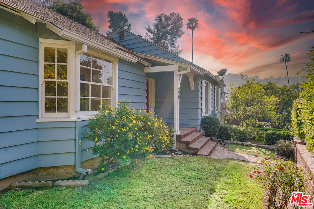Charming Hollywood cottage for lease located in the highly coveted Lake Hollywood Knolls offers modern amenities with original details. Situated behind a wall of well-manicured hedges that provide privacy and serenity, this traditional 2-bed / 2-bath home boasts generous natural light throughout, original wall niches, two fireplaces, and plenty of storage. The updated eat-in kitchen includes stainless steel appliances and ample cabinetry. The large living room offers plenty of room for entertaining and relaxing. The primary suite features lots of closet space, original built-ins, and a beautifully remodeled full bathroom. The second bedroom or den has a rounded brick fireplace, giving it a cozy atmosphere. The bedroom's closet is adjacent to its bath. An additional bonus room with outdoor access can be used as an office. A loft above the bonus room provides extra storage space. The private hillside backyard features orange and lemon trees as well as space for entertaining. The attached two-car garage with an adjacent bonus room -perfect for an exercise space or additional storage - and laundry room are accessible via stairs up to the main living area. Close to major studios: Universal, Warner Bros., Disney, and Netflix. Shopping close to Whole Foods, Trader Joe's, Ralph's, and Von's Markets, and restaurants. Three-quarters of a mile to the Hollywood Bowl and 12 minutes to the Burbank Airport! Home equipped with solar panels. The landlord pays the gardener. Both fireplaces are considered decorative only. Applicants must have excellent credit. Available immediately.