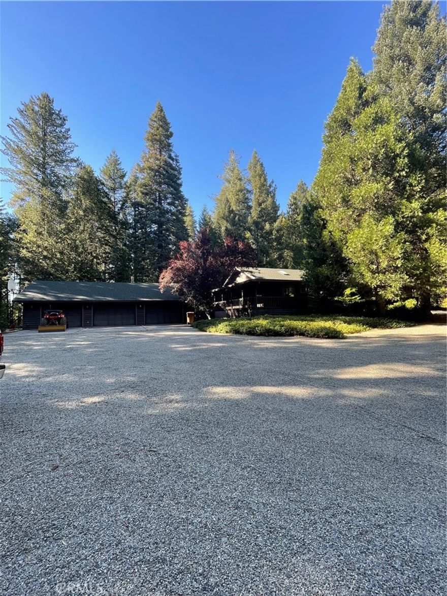 Welcome to a beautiful exclusive area in Magalia near Paradise Lake (www.paradiseprpd.com/paradise-lake).  All homes are custom built homes. Home is nestled and surround by trees on sprawling 5.50 acres that is entirely fenced.  Offering the freedom of privacy and buffer from seeing your neighbor.  Hardwood floors and new carpet.  The expansive living room with high ceilings, creates an inviting atmosphere with a wood burning stove for those cold nights.  Large spacious kitchen with large island. Stainless steel appliances, and a gas range combining style and function  Extremely large pantry with separate wine room!    Well-equipped laundry room/mudroom also  with several built in cabinets.  Wrap around deck ideal for outdoor entertaining!   2 hot tubs that will stay with the home.  1 hot tub outside on deck for those warm summer days and 1 hot tub inside in a separate room off from the front room.   All bedrooms have ceiling fans to keep you cool in the warm summers.  Primary bedroom, featuring an on suite bath with dual sinks and a generously sized walk-in closet.  Generac generator for power emergencies.  Oversized gravel drive way and walk ways.  3 car garage with studio room that has wood burning stove and bath that can be rented out or for a mother in law.  For the fishing enthusiast, kayakers or bike riders, Paradise like within 5 minute walking distance. Whether you are looking for peace, space for your toys, or a place that truly feels like home, this gem delivers.