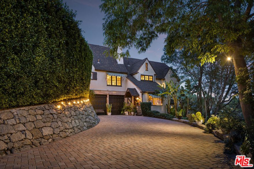 Peacefully tucked amidst the treetops of Beachwood Canyon, this fully furnished 1920s French Normandy chateau is a luxurious retreat where Old Hollywood charm meets modern sophistication! With breathtaking views of the Hollywood Sign, Griffith Observatory, and the iconic Los Angeles skyline, this secluded oasis offers an unparalleled experience in the Hollywood Hills. Step through the arched entryway and be transported to a world of eleganceexquisite walnut millwork, soaring truss ceilings, and abundant windows bathe the home in natural light. Cathedral ceilings tower over the living room's stone fireplace and scenic French doors, opening to a picturesque deck that set the stage for unforgettable evenings under the stars. A designer chandelier lends a relaxing mood for intimate gatherings in the dining area. Crafted for the avid cook, the gorgeous kitchen features premium appliances, custom cabinetry, a distinctive backsplash, and gleaming marble countertops. Three generous bedrooms invite you to unwind after a long day, the grandest of which is the primary suite with its exclusive balcony, walk-in closet, and opulent ensuite. Multi-level outdoor seating areas, a covered fitness alcove, and lush greenery make this home an entertainer's dream. Notables include the versatile loft with a separate entry, kitchenette, and a long, gated driveway offering ample parking. Its elevated location makes this sanctuary feel remote despite being only moments from the heart of LA. House is offered fully furnished and available for rent 1/8/2026