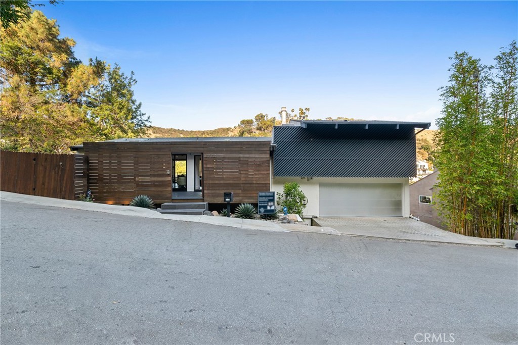 Mid-Century Magic with Unreal Views + Seamless Indoor-Outdoor Living – Moments from Iconic Sunset Strip!
Tucked in lower Nichols Canyon, surrounded by multi-million dollar homes, just minutes from the Sunset Strip & West Hollywood’s finest dining, nightlife, and energy & trails, this mid-century modern retreat delivers timeless style, jaw-dropping views, & the kind of indoor-outdoor flow that defines LA living. Set behind a gated entry, the home opens to a spacious private front patio—rare, usable outdoor lounge perfect for slow mornings, sun-soaked workdays, or evening cocktails before heading out. This outdoor space connects effortlessly to the interior, setting the tone for a lifestyle rooted in openness, light, & flow. Inside, vaulted ceilings, exposed beams, & wide-plank flooring create an airy, architectural feel. Floor-to-ceiling sliding glass doors dissolve the boundary between inside & out, drawing you toward the upper view deck, where you’ll host unforgettable dinners, cocktails, easy al fresco dining & entertaining or laid-back sunset hangs w/canyon & twinkling city lights as your backdrop. Cook's kitchen is bright, stylish, featuring clean lines, top of the line stainless steel appliances, contemporary counters, & skylight that floods the space with natural light. The primary suite is your private retreat, w/oversized windows framing sweeping canyon views, built-in storage, & spa-like bath with a soaking tub, glass shower, and skylight—letting you shower under the stars. Each of the two additional bedrooms also offers uninterrupted canyon views, making them ideal for guests, a creative studio, or the perfect Work From Home setup. One features a charming fireplace. A second modern bathroom with sleek finishes completes the main level.
Highlights include:
• Stunning views from every ROOM!
• Iconic mid-century architecture + vaulted ceilings
• Floor-to-ceiling sliders + open-concept design
• Seamless indoor-outdoor living
• Skylights in kitchen + primary bath
• Huge front patio + entertainer’s upper deck
• Attached 2-car garage + updated systems
• Minutes from Sunset Strip & West Hollywood dining, nightlife, and hiking
This home is more than a space—it’s a lifestyle made for connection, creativity, and unforgettable moments.
Come see the magic