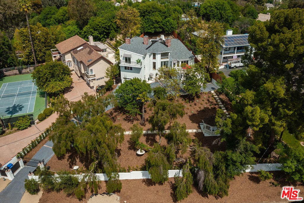 Discover the rare opportunity to call this extraordinary gated and secluded estate your home. Set on a private lot and surrounded by nature, this beautifully renovated residence offers nearly 4,000 square feet of refined living space. The main house features 4 spacious bedrooms and 3.5 luxurious bathrooms, while a detached guest house includes its own full bath, ideal for visitors or extended stays. Recently updated from top to bottom, the home boasts a brand-new chef's kitchen equipped with energy-efficient appliances, custom cabinetry, and modern finishes. Every detail has been thoughtfully upgraded, including new windows, doors, multi-zone HVAC, and a stunning saltwater pool and spa complete with built-in BBQ and outdoor fireplace, perfect for entertaining.Upstairs, the serene primary suite offers a cozy fireplace, private balcony overlooking the lush backyard, a spa-inspired bath with standing shower, jetted soaking tub, dual vanities, and a generous walk-in closet. A long, gated driveway leads to both a single-car and a two-car garage, with ample space for parking 5+ additional vehicles. The whimsical yard feels like a private retreat, featuring a new gazebo, outdoor fireplace, and a fire pit perched on an elevated deck, all framed by panoramic mountain views. This home is a true celebration of indoor-outdoor California living.
