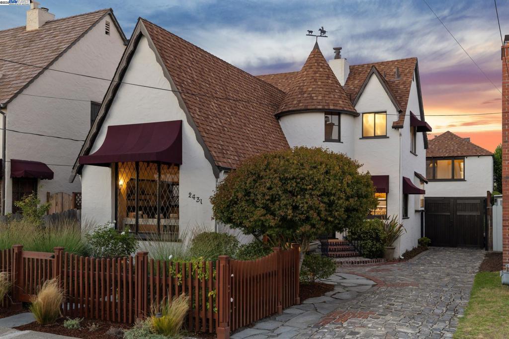 A weather vane-topped turret, a leaded glass picture window set in a stucco exterior, steeply pitched roof lines, a rustic cobblestone driveway & a lush native garden behind a sweet picket fence all add to the irresistible fairytale charm and curb appeal of this wonderful storybook-style Tudor Revival home! Located just blocks from the shoreline + South Shore Center amenities, this 1938 home features 2BR, 2.5BA, formal living/dining rooms, a kitchen with an adjoining breakfast room, a spacious pantry/mudroom & a large, finished loft space over the detached garage. Loads of fanciful storybook details include a whimsical interior stairway, a w/b fireplace with a slate/stone surround built into an inglenook, original cupboards and bookcases (and a turret + built-in settee!), wall niches & a fabulous living room barrel ceiling adorned with wood panels and beams. Wood floors throughout, new light fixtures, an updated primary BR, quartz kitchen counters + a huge pantry/mud room off the kitchen that provides additional storage and/or kitchen expansion potential. A spacious loft + full bathroom above the detached garage makes a great home office, family room or guest/teen space (236 SF). A fabulous home, great location near top schools, great shopping + many convenient commuter options!