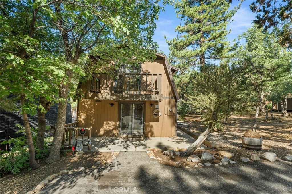 One of the lowest price-per-square-foot homes in Sugarloaf, this property offers incredible value for those looking to own a true mountain getaway. Surrounded by towering pines and leafy oaks in a neighborhood just a block from the National Forest, this charming gambrel-style cabin offers the perfect blend of comfort, room to relax, and character. With 4 bedrooms, 2.5 baths, and 1,485 sq ft of living area, there’s plenty of room for everyone to gather—whether around the wood-burning fireplace in the spacious living room with exposed beams or in the charming dining area that looks out onto the trees. Cozy and inviting, the home features knotty pine ceilings, dual-paned windows, a laundry room, a new heater, and paved parking that conveniently fits three cars. The primary bedroom includes its own balcony, and the three additional bedrooms are generously sized. Outside, the sunny front patio invites lazy afternoons and cool mountain breezes, while endless trails and scenic beauty are just a block away. Set on a 3,700 sq ft lot with a large shed for storage, this peaceful retreat is being offered for the first time in over 30 years. It’s an ideal family getaway, investment opportunity—or both. Start your mountain adventure today. **Photos include some virtual landscaping and staging.
