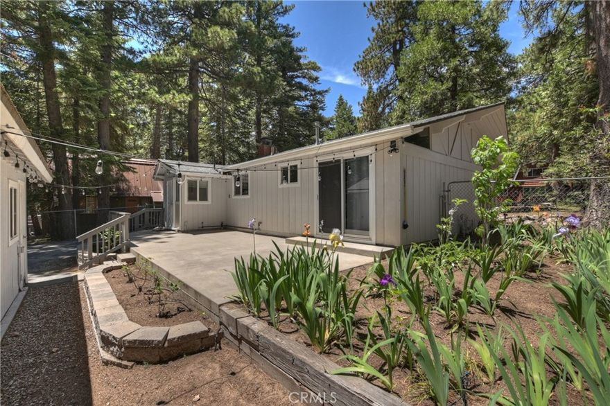 What a single level treasure! This home fits the bill for so many buyers-perfect starter home, perfect weekend get-a-way and the perfect retirement home! Well thought out for easy mountain living, this attractive home has level access, loads of parking (included RV!), wood burning fireplace insert, fenced yard, garden areas, large rear patio and a garage with a half bath and gas heater! This single level home is move in ready with upgraded wood look laminate floor, newer paint and carpet and updated kitchen. The home features the living room with a brick fireplace, dining area, an open kitchen, 2 bedrooms (one has a slider out to the rear patio), full bath and a laundry room. There’s also a large storage shed attached to the garage offering you lots of room for your tools and toys! Affordably priced, this one is not to be missed!