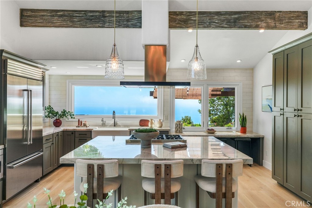 Incredible Pacific Ocean Catalina Views from this reimagined 4-bedroom, 3-bathroom home. Upon entering, be immediately greeted with a light and bright interior featuring high vaulted ceilings, fresh paint, and beautiful European Oak engineered wood floors. Adjacent to the foyer is the first of two living spaces, which is open to the dining and kitchen area. The Chef's kitchen is an entertainer's dream with high-end Sub-Zero and Thermador appliances (installed in 2024), large center island, one-of-a-kind quartzite countertops and gorgeous panoramic ocean views. Other highlights include the ocean-facing eat up bar and newly installed reverse osmosis water filtration system with insta-hot faucet. Step down to the second living space that opens to the backyard and features a gas fireplace and wet bar with beverage fridge. The downstairs level is completed with a separate bedroom and full bath -- perfect for guests, an older child, in-laws, or home office. Upstairs, the spacious primary suite offers separate dual vanities and closets, marble tile, and sizable balcony. Additionally upstairs are the generously sized third and fourth bedrooms (one with private balcony) that share a hall bath. This coastal retreat has plenty of storage throughout, updated recessed lighting, and dual zone ACs. Additional storage is provided by the 3-car garage with direct access. New flush, smooth dark bronze garage doors with side mount openers were recently installed. The backyard is low maintenance with new drip system and sprinklers and is the perfect place to relax and enjoy the fresh, cool ocean breeze. The oversized, street to street lot offers privacy and room for additional improvements. This highly sought after Mira Catalina neighborhood within PVPUSD (ranked #2 in all of LA County according to Niche) is known for its sweeping views, underground utilities, and its tranquil nature surroundings. Convenient access to the 110 and only minutes to shops and restaurants, yet you'll feel worlds away while enjoying the ever-changing ocean scenes of ships and dolphins and spotting the local hummingbirds and red-tailed hawks. Hiking and biking enthusiasts alike will appreciate access to the Forrestal Reserve trail system via the Coolheights Trail just down at the end of the street. The location and proximity to the ocean provide for, arguably, one of the best microclimates in the area. Schedule your showing today to experience a taste of the California Coastal dream lifestyle.