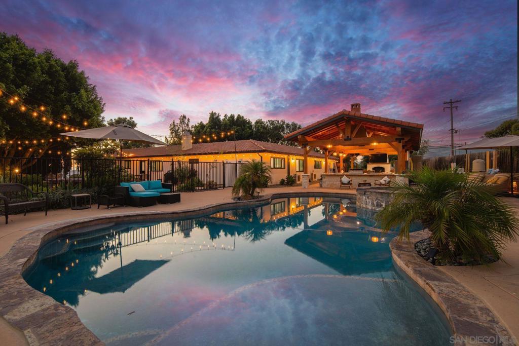 Welcome home to 14085 Proctor Valley Road – a beautifully renovated Jamul estate on 1.26 useable acres with modern upgrades, resort-style amenities including a pool/spa, and versatile living options! The single-story 4BR/2BA main home has been thoughtfully reimagined with all new high-end finishes and updates throughout. A very spacious primary suite features an incredible spa-like ensuite bathroom and oversized walk-in closet. Open living areas create seamless flow for daily living and entertaining. An incredible bonus, this home features a separate 1BR/1BA Junior ADU with its own full kitchen and laundry, simply perfect for guests, extended family, or rental income. RV hookups with a separate septic and electric panel add even more convenience! Outside, enjoy a sparkling pool and jacuzzi, expansive covered patio with firepit, full outdoor kitchen, and outdoor TV—ideal for entertaining. Additional highlights include a high-end putting green and a children’s play area under a stunning generational tree, creating a fun and functional backyard retreat. All this in a peaceful Jamul setting just minutes from shopping, dining, and schools—yet less than 20 miles to Downtown San Diego and the airport. With scenic trails and hiking nearby, this estate at 14805 Proctor Valley delivers the best of stunning country living with acreage!