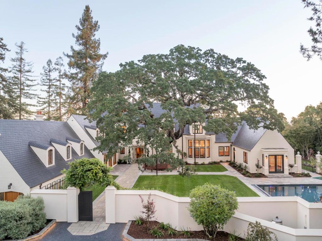 Completely Renovated inside and out! This architectural Jewel with Dazzling Views! Originally imagined by the visionary architect Gardner Dailey in 1934, this exceptional estate is a testament to his architectural brilliance updated with a complete comprehensive renovation. The classic style of a country manor is presented, creating a visual symphony from the slate tile roof to the leaded glass windows and exceptional gardens. The views offered are nothing short of dazzling, encompassing verdant views of the bordering Menlo Country Club golf course, the sweeping panorama of San Francisco Bay, and the majestic silhouette of the East Bay hills. Set within a gated sanctuary of 1.5 acres, the home is adjacent to a 2.8 acre lot available for separate acquisition, enhancing the promise of exclusivity or with potential for further development. The palatial home spans more than 10,000 square feet of grace and sophistication. The journey into the home begins with a unique entrance a pedestrian gate beyond the gated driveway opens into a vast front courtyard with a magnificent heritage oak tree, lawns and patios, and pool, creating an enchanting space for grand celebrations or private relaxation. This is a once-in-a-lifetime property! Gorgeous Gardner Daley Home.