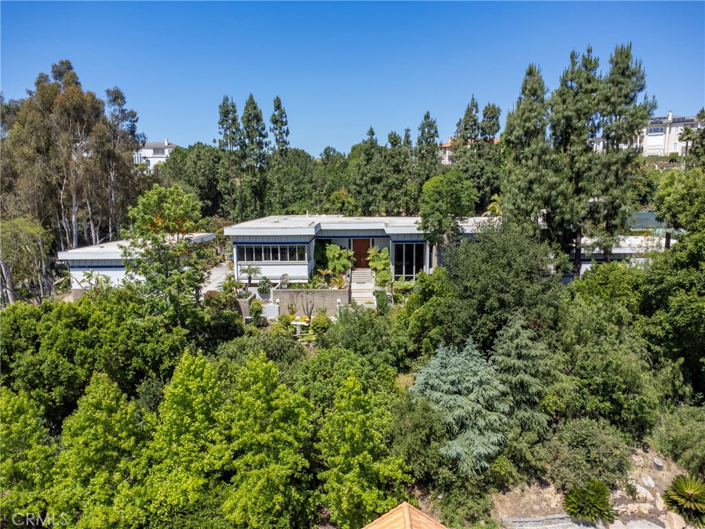 Welcome to 23615 Falcons View Drive — a truly exceptional estate located in the prestigious, guard-gated community of "The Country" in Diamond Bar. Set on nearly 2 acres of private, usable land, this one-of-a-kind custom home was thoughtfully designed to embody architectural artistry, intentional flow, and timeless sophistication.
Spanning over 6,000 square feet, this estate blends artful design with elements of Frank Lloyd Wright’s organic architecture and strategic orientation. Subtle Feng Shui principles guided the original layout — promoting natural energy circulation, harmonious room placement, and a calming balance between openness and privacy.
The 13-foot grand foyer immediately sets the tone, welcoming you with abundant natural light and striking symmetry. The layout is fluid, with wide hallways, and seamless transitions that create an effortless flow between living, entertaining, and retreat spaces.
The home features 5 bedrooms and 7 bathrooms, including a private primary retreat with a spa-style bathroom, generous walk-in closets, a personal sauna, and a hot tub for the ultimate relaxation experience. A separate guest wing with its own maid’s kitchen provides ideal flexibility for long-term guests, multi-generational living, or staff quarters.
At the heart of the home is a chef’s dream kitchen, thoughtfully designed with top-tier appliances, abundant prep space, and direct access to the main living and dining areas — perfect for entertaining or everyday culinary enjoyment.
Additional highlights include a museum-style gallery wing, a dramatic sunken conversation lounge, a beautifully finished wine cellar, fitness room, and an oversized 6+ car garage that could serve as a showroom, studio, or creative space.
Step outside to enjoy the best of Southern California living: a resort-style pool with integrated spa, poolside cabana, tennis court, and mature, professionally landscaped gardens designed for both beauty and privacy. Total property square footage adds to nearly 8,300 including the below grade wine cellar and art gallery museum/gym adjacent to the tennis court.
23615 Falcons View Drive is a rare offering — a home where architecture, energy, and lifestyle come together in perfect alignment. Shown by private appointment only.
