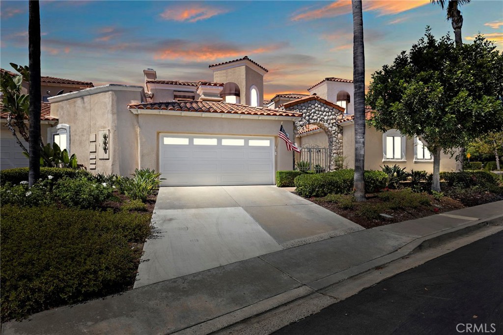Welcome to 15 Via Barcaza, an elegantly upgraded residence in the highly desirable Los Verdes enclave of Coto de Caza. This beautifully maintained home offers 3 bedrooms, 2.5 bathrooms, and 2,102 square feet of thoughtfully designed living space. The main level features a luxurious primary suite with a spa-inspired bathroom showcasing a soaking tub, walk-in shower, and dual vanities. A unique no-step-down open floor plan seamlessly connects the family room, dining area, and upgraded kitchen, creating the perfect space for gatherings. The kitchen is enhanced with granite countertops, stainless steel appliances, bar seating, and a charming breakfast nook. High ceilings, skylights, and newer Milgard high-efficiency windows (with transferable warranty) flood the home with natural light. Upgrades include travertine tile flooring, crown molding, plantation shutters, French doors with mini blinds, and upgraded baseboards throughout. A cozy fireplace adds warmth to the inviting family room, while an awning off the patio keeps the home bright yet comfortable year-round. The backyard is a true highlight—featuring a newly remodeled patio, ample space for entertaining, a fenced-in area for pets, and room for grilling or gardening. Upstairs, two spacious secondary bedrooms share a remodeled bathroom and open to a balcony with hillside and sunset views. Practical updates add peace of mind, including a newer water heater (with warranty), newer PEX repipe (with warranty), and an attached two-car garage with built-in storage and laundry area. Set in the guard-gated community of Coto de Caza, this home offers both privacy and convenience. Residents enjoy access to miles of trails, parks, and the nearby Coto de Caza Golf & Racquet Club, featuring two Robert Trent Jones Jr. championship courses. Exclusive membership opportunities are available for golf, pickleball & tennis, fitness, swimming, and social amenities, offering a true resort-style living experience. 15 Via Barcaza is more than a home —it’s a lifestyle of comfort, elegance, and endless opportunity for entertaining and relaxation.