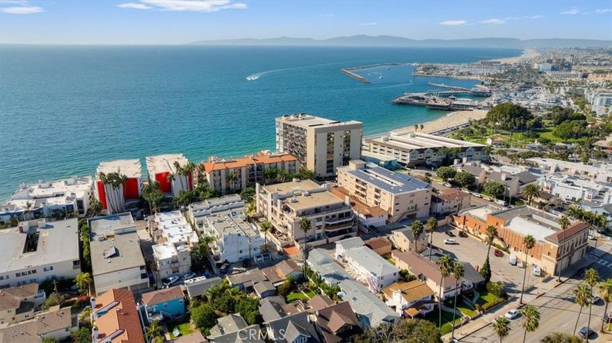 Prestigious Penthouse complex on the Esplanade! Rare end-unit in a secure 13-residence building offering privacy, luxury, and unbeatable beachside living. This spacious condo lives like a home with 2 large bedrooms, including a primary suite featuring a remodeled spa-inspired bath. Wraparound patio showcases breathtaking city-light views at night and stunning sunrises in the morning. Upgraded with custom tile floors, chef’s kitchen with dark wood cabinets, light stone island, and top-of-the-line appliances. Walls of windows flood the unit with natural light. This condo is STUNNING! Resort-style amenities include pool, spa, sauna, gym, and billiards room—all just steps to the sand. Truly a rare opportunity to own one of the most desirable residences on the Esplanade!