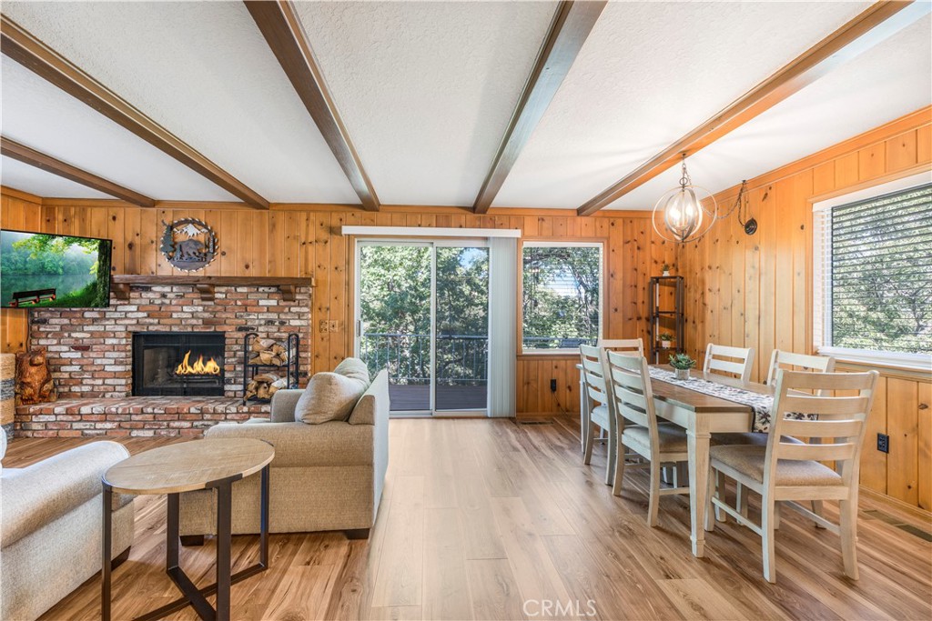 Dock included!! Lake rights, treed privacy, level entry, and multiple living spaces highlight this Lake Arrowhead home.
The main level offers a functional and comfortable layout, beginning with a living room centered on a wood-burning fireplace. This room opens directly to the kitchen and dining area, creating an easy flow for daily use. Sliding doors extend to a large deck that is sized for outdoor furniture and designed to capture tree views and seasonal sunsets. A bedroom is also located on this floor, allowing for true single-level living. This feature is especially convenient for those who prefer to avoid stairs while still enjoying a spacious mountain property.
The lower level is designed for additional living space. A generous game room includes a pool table, seating area, bar setup, and a second fireplace. This level also opens to a second deck, providing another area for outdoor enjoyment. The flexible layout makes this level useful for recreation, guests, or extended family.
The home is positioned on a treed lot that has been kept clean and well maintained. A circular driveway at the front of the property makes access simple, while dual access below the home provides even more options for vehicles, equipment, or storage. To the left of the home there is dedicated boat parking, making this a practical choice for buyers who plan to take advantage of the included dock.
Additional features of this property include multiple decks for outdoor use, two fireplaces, a game and bar area, and off-street parking for both cars and recreational vehicles. The dock, included in the sale, provides direct access to Lake Arrowhead and enhances the property’s value. A nearby lakeside area can be used for picnics or relaxation by the water.
Located near riding areas, hiking trails, and outdoor recreation, this home is positioned to take advantage of both lake and mountain amenities. The combination of level entry, multiple indoor and outdoor gathering spaces, and ample parking make this a versatile Lake Arrowhead property.