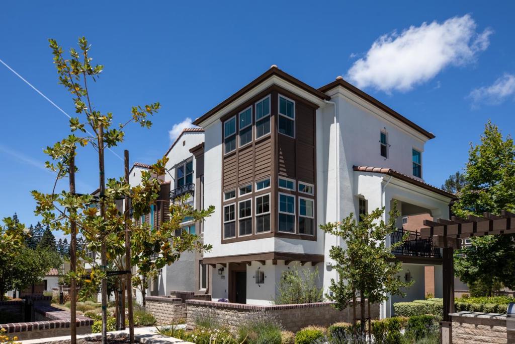 This gorgeous 3 bedroom, 2.5 bath home with a private courtyard offers abundant amenities, plentiful light throughout, soaring ceiling heights and a sophisticated lifestyle overlooking greenery and verdant gardens. Built in 2020 by Dividend Homes, this is one of only 4 corner units in this 55 townhome complex in the highly coveted Maravilla Community. Well situated to parks, shopping, tech companies and transportation this home is a 10! Within the community there is a park with a large double BBQ area, spacious open green space, appealing swings and relaxing fountain area with well-appointed gardens plus a bark park for the family pet. Guest parking and car charging stations add great convenience to this neighborhood oasis.Other amenities include: hardwood floors, newly-carpeted stairways, designer window treatments, AC with multiple zones, attached 2-car garage with a storage unit and hookup for EV charging. HOA: $387/month includes common grounds, common area electricity, common area gas,garbage, landscaping/gardening, maintenance of the common area, reserves. This elegantly modern home has that cool vibe for entertaining and relaxing that you will not want to miss. What an amazing lifestyle!