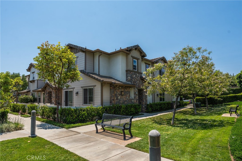 Beautiful Plan 4 Covington homes end unit built in 2016 and remodeled in 2025, with 3 up plus loft and mainfloor bdrm and full bath down. GORGEOUS kitchen with all the extras is wide open to great room with fireplace. This home has been meticulously amd thoughtfully upgraded and remodeled. Primary suite upstairs is generously sized and the bath is spa like with brand new stand alone tub, brand new separate shower and brand bew vanities and tile flooring. 2 more bedrooms upstairs plus convenient loft is a 2nd family room area or maybe an office? Fresh paint gives the interior a beauitlful, airy, newer feel, and gorgeous designer-grade laminate throughout for easy care is a modernizing touch. Mainfloor bedroom is good sized adjacent from kitchen and mainfloor bath is new and beautilful with vanity, new flooring and new shower with barn door style rolling door. Interior laundry room is upstairs for added convenience. Great outside perimeter location on west side of tract with parking and 2 car garage with new epoxy coated floor. Small patio off living room. Large grass/greenbelt is in middle of complex and community pool, spa and clubhouse are in center of complex at entrance. Complex is located across from Nixon Presidential Library, a short distance to shops, restaurants, post office and Yorba Linda Town Center with movie theater and grocery store.