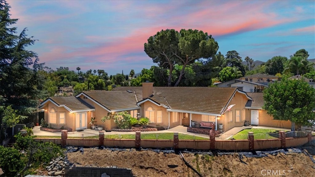 Welcome to this beautifully maintained custom 3,000 sq ft single-story home, ideally situated on a spacious .6-acre horse-zoned lot in a quiet and desirable Corona neighborhood. Designed with comfort, efficiency, and functionality in mind, this home offers 4 generously sized bedrooms, 2 full bathrooms, and a half bath, with a smart, open layout perfect for family living and entertaining. Enjoy a light-filled interior featuring a chef’s kitchen with a large center island, walk-in pantry, and ample cabinetry, all flowing seamlessly into the family room—ideal for casual gatherings. A formal dining room and welcoming living room add charm and versatility to the space. The primary suite is a private retreat with its own office/sitting area, walk-in closet, and spacious ensuite bath. A large laundry room includes a soaking sink, perfect for utility and ease. This home features two fireplaces: one gas-burning fireplace and a unique wood-and-gas fireplace complete with a built-in wood box, adding warmth and character to the living spaces. Additional thoughtful upgrades include a climate-controlled garage, a walk-through attic for easy-access storage, and a suite of modern utility systems for ultimate comfort. Enjoy a whole-house water softener system, a tankless water heater, and a reverse osmosis water filtration system—all enhancing your quality of life. Eco-conscious buyers will appreciate the owned solar panel system paired with two Tesla Powerwall batteries, reducing energy costs while boosting
energy reliability. A durable tile roof adds to the home’s long-term value and appeal. Step outside to a beautifully laid-out entertainer’s backyard with room to relax, dine, or play. The expansive lot offers endless possibilities, from creating a garden oasis to adding a pool, ADU, or using the space for equestrian or recreational needs. ******Title shows gross area 3624 square feet, includes 624 sft. climate control garage, which could easy be converted to ADU*********