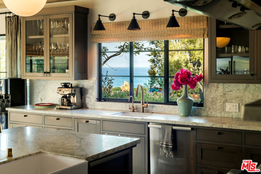 A once-in-a-lifetime Point Dume estate with rare deeded beach keyed access and a private backyard path to Little Dume. Elevated above the surf and nestled off and away from the bluff , this iconic one plus acre compound offers unobstructed and wind protected ocean views that span the entire estate. An irreplaceable and pristine home blending effortless luxury with resort-style living. Purposefully designed to include a sun-drenched pool, ocean-facing gym, a tucked away enclave with custom skate bowl, zipline and treehouse; and a designated surf-ready setup with outdoor shower and board locker. The elegant four-bedroom single level main home is paired with a private guest house above the four car garage, complete with a full kitchen and space to comfortably sleep four. Ocean facing and adjacent to the pool is a detached destination gym and a separate pool house that features a chef's kitchen, commercial-grade pizza oven, and built-in daybeds; ideal for post-swim lounging or overnight guests. This is not just a home, it is a haven for privacy and immediate enjoyment, designed for those who understand the value of the truly unrepeatable.