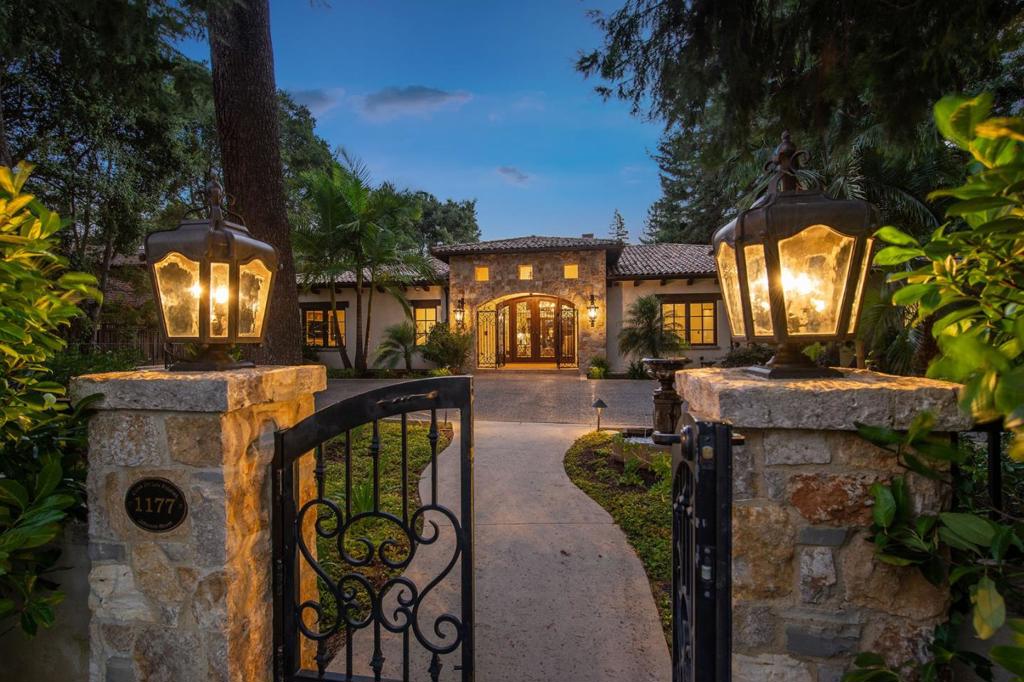 Inspired by California Mission architecture this impeccable custom home in downtown is set on a rare estate lot. Every detail is solid & exquisite from antique French roof tiles to hand scraped walnut floors. Grand scale living room with beamed ceiling & yellow osage stone fireplace opens onto central courtyard & expansive rear grounds with pool & spa, indoor/outdoor entertaining pavilion & 1bd/1ba guest house. Designed to live as a single story home, main level features en-suite bedrooms, office w/ full bath, separate family room and a large chef's kitchen w/ limestone counters and breakfast room. Amenities placed conveniently on basement/lower level w/ elevator access - 2 additional bedrooms w/ separate entrances, movie theater, spa bath, dry sauna, 4 car showplace garage, wine cellar & tasting room. Back up generator, 4 zone heat & AC, full security w/ video surveillance. Once in a lifetime opportunity for estate living with the convenience and easy lifestyle of downtown living.