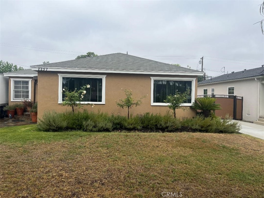 Welcome to this charming 2-bedroom, 2-bathroom home located in the heart of South Wrigley, Long Beach. Featuring beautiful hardwood floors throughout, this spacious residence offers a flexible floor plan with possible third bedroom or home office. The home boasts a formal living room, a large formal dining room, and a cozy family room, all designed for comfortable living and entertaining. A double-sided fireplace adds warmth and character, connecting the family room and the adjoining office/den or 3rd bedroom ideal for work-from home days or relaxing evenings. The expansive kitchen offers plenty of space for cooking and gatherings with family and friends. Outside, enjoy a long driveway leading to a detached 2-car garage and a lush yard filled with mature fruit trees-perfect for outdoor ling and homegrown produce. Located in the desirable South Wrigley neighborhood, this home offers convenient distance to shopping, freeways, downtown Long Beach, and not far from the beach.