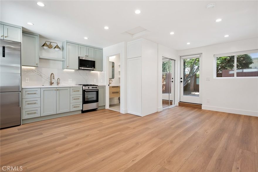 Welcome to this stunning, newly remodeled garage-conversion ADU, 4039 Colonial Avenue Unit A. This spacious studio unit perfectly blends modern design with functionality. Enter through a private gated entrance into a front patio surrounded by greenery, then stop inside to brand-new everything! The kitchen is a true showstopper with sage green cabinetry, brass hardware, stainless steel appliances, quartz countertops, and under-cabinet accent lighting. A beautifully designed private bathroom offers abundant storage and a large walk-in shower. The stackable washer and dryer are conveniently tucked away in a custom cabinet with additional overhead storage, making everyday living simple and efficient. Across from the kitchen, there is space for a cozy living room setup, while a rolling kitchen island can serve as both a room divider and a dining area with barstool seating. At the rear of the unit, the bedroom area features a large closet and a glass door leading to the backyard, offering an opportunity for privacy with the use of a room divider. Flooded with natural light from the numerous windows and enhanced with recessed lighting throughout, the home feels bright, airy, and inviting. The star of the show is the private backyard. This rare, extra-large outdoor retreat is fully gated and features a brick patio and garden area, offering the perfect place to host friends, enjoy a morning cup of coffee, or relax in peace. Gas and water are included in the rent, and the unit benefits from Culver City schools and services. Situated in one of the most desirable neighborhoods, you’ll enjoy convenient access to an incredible selection of shops and restaurants along Washington Boulevard, including the Lucky mixed-use development and the highly anticipated Culver Public Market Hall. Major offices such as HBO, Amazon, and Apple are just moments away, along with popular local favorites like Hatchet Hall and the Mar Vista Farmers Market. This Culver City gem is more than just a rental, it’s a lifestyle.