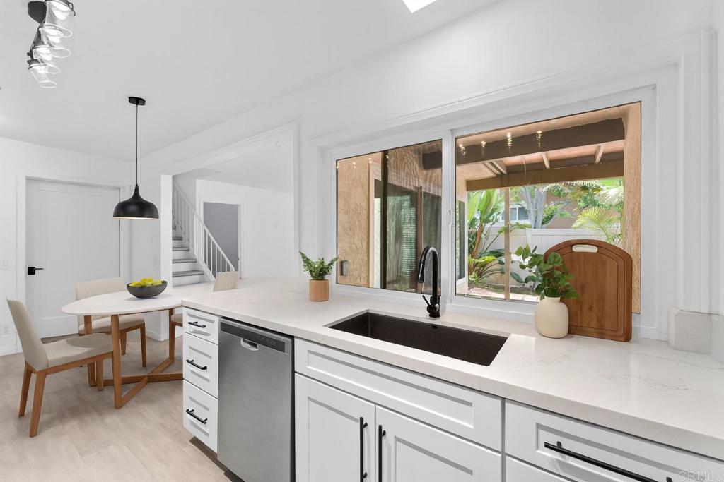 Welcome to this beautifully updated townhome in the highly sought-after Village Park community of Encinitas. This light-filled 4-bedroom, 3-bath home combines comfort, functionality, and modern style. The updated kitchen features crisp white cabinetry, newer countertops, and upgraded windows that invite natural light throughout the space. The open-concept layout includes newer flooring, a cozy fireplace in the bonus room that could be used as a 4th bedroom/office and a private patio perfect for relaxing or entertaining. Upstairs, the spacious primary suite offers vaulted ceilings and a walk-in closet, with two additional bedrooms ideal for family, guests, or a home office. Additional highlights include an attached 2-car garage, in-unit laundry, and access to community amenities like a pool, greenbelts, and parks. Located in the top-rated Encinitas Union and San Dieguito Union High School Districts, just minutes to local beaches, shopping, and dining. This is your chance to enjoy the Village Park lifestyle in coastal Encinitas.
