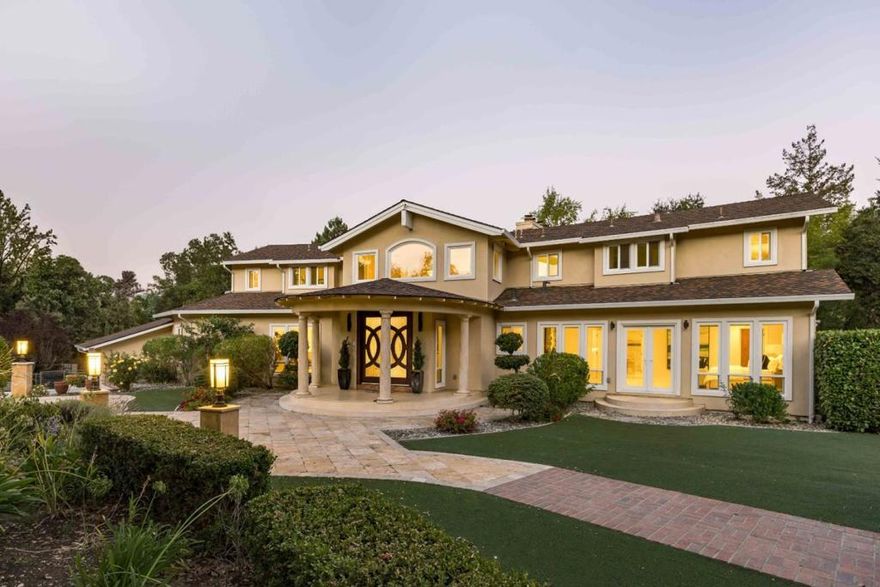 Sanctuary awaits on over an acre. Beyond an extended driveway lies a spectacular estate that has been meticulously upgraded to perfection. With a flawless blend of opulence and warmth, the nearly 7,200 sf of space invites grand-scale entertaining while providing all the comforts of daily living. Virtually every lifestyle need has been considered, from generous gathering areas and a gourmet kitchen to an executive office, a sprawling game room, a cinema-quality theater, and lavish bedrooms highlighted by a retreat-inspired primary suite. All-encompassing grounds reflect the lush surroundings, offering a five-star resort experience complete with an indoor/outdoor pool and a lighted tennis court. And though you will feel tremendous privacy inside of its gates, this estate is conveniently located mere minutes from downtown Los Altos and an esteemed country club, with access to sought-after public and private schools (buyer to verify eligibility).
