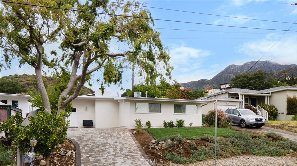 Don't miss out on the chance to visit this beautiful single-story Tujunga gem! The property features a sparkling in-ground pool with mountain views, and a generous 5,900 sq. ft. lot. The spacious 3 bedrooms and 3 full bathroom floor plan has been thoughtfully laid out across 1,313 sq. ft. of living space offering a turnkey home that boasts comfort, style, and function all in one.
As you step inside you're welcomed into an open-concept layout filled with natural light, where the bright living room flows effortlessly into the backyard through a sliding glass door inviting a perfect for indoor/outdoor living space right for feeling at home and entertaining guests. The modern kitchen design is complete with quartz countertops, stainless steel appliances, tile backsplash, and ample cabinetry for the culinary enthusiast.
Retreat to a serene primary suite with a walk-in closet and spa-like ensuite bath featuring floor-to-ceiling tile. The other bedrooms offer generous space, large windows, and ample storage. Step outside to your private entertainer’s paradise, with lush greenery, brick pavers, a large gardening area, and of course, that inviting pool.
Enjoy central air and heat, in-unit laundry, recessed lighting, and laminate flooring throughout. Tucked away on a quiet street in the foothills with sweeping views of the mountains and city lights, yet minutes from DTLA, Glendale, Pasadena, and Burbank you'll discover that this location offers just the right amount in both peace and convenience. Visit this magnificent property during open house hours or book a tour today!