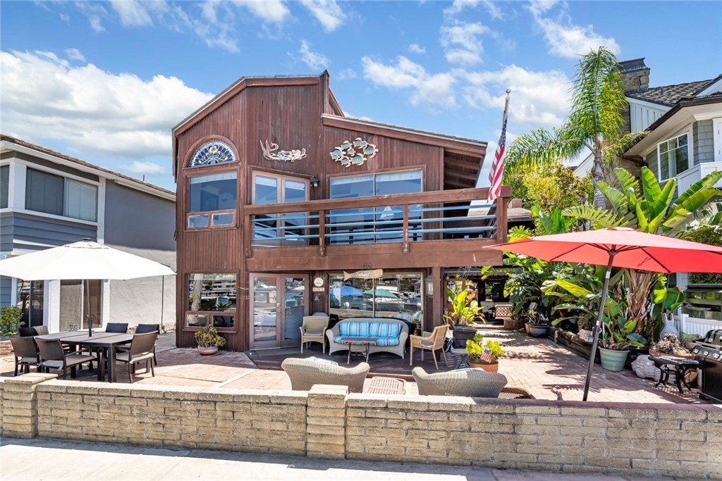 Defined by the charm of an island getaway, this fully furnished large 3-bedroom, 3-bathroom home at 805 North Bay Front offers a break from the everyday. The oversized lot offers an impressive stretch of view across the harbor that is capitalized on each level. Property features an enormous patio that wraps around the side into mature tropical inspired landscaping. Quartz countertops in the kitchen add a touch of modern framed up with the distinction of hardwoods and earthy tones throughout the home. Home features dual master bedrooms with large bedrooms and plenty of closet space. This property has a casual and seamless indoor-outdoor living experience, ideal for enjoying the ocean breezes year round. Included with rental is the personal use of the Duffy at the dock so you can explore the coast at your leisure. One carport space on the rear of the property with easy access of the alley.