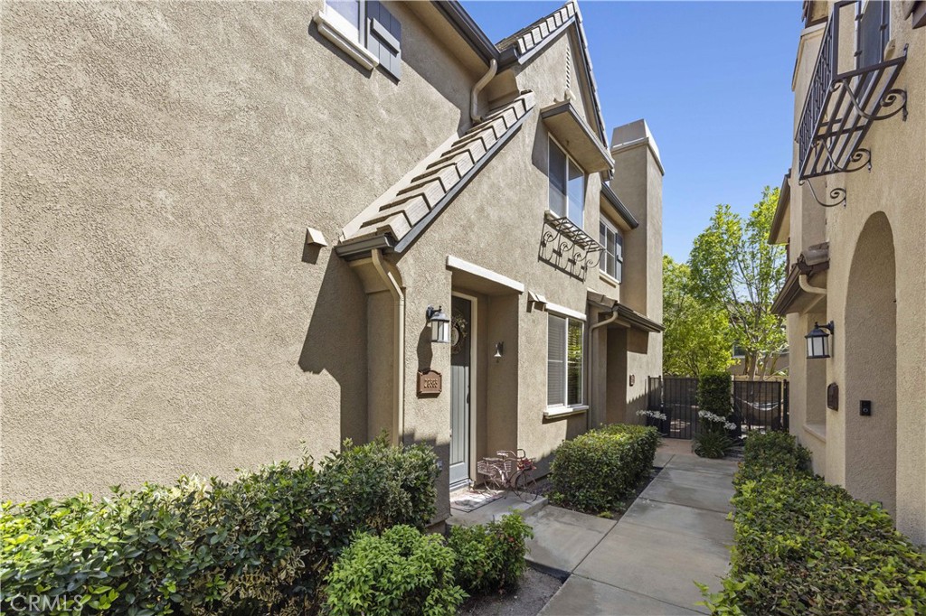 Welcome to 28385 Mirabelle Lane in the highly desirable Mariposa community of Saugus! This beautifully upgraded 2-bedroom, 2-bath townhome offers a stylish and comfortable living space with wood flooring throughout, tile in the bathrooms, and a neutral paint palette completed just three years ago. The upgraded kitchen features sleek LG stainless steel appliances, a stunning copper farmhouse sink, and custom cabinetry, flowing into a bright living area with a built-in entertainment center and ceiling fans for year-round comfort. Both bathrooms include copper sinks and tasteful finishes, and the secondary bedroom features a chic barn door. Indoor laundry adds convenience, while the private balcony is perfect for entertaining with a gas BBQ that stays with the home. Enjoy the charm of plantation shutters throughout and a direct-access garage, also includes a covered carport. Located in the resort-style Mariposa community with low HOA dues, residents enjoy a pool, spa, clubhouse, BBQ area, playgrounds, and scenic greenbelts all within minutes of top-rated schools, shopping, and dining. This move-in ready town-home checks every box for comfort, convenience, and style.