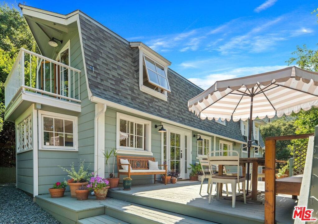 This majestic compound is a truly unique property composed of one 3 bedroom/2.5 bath home and a separate 1 bed/1 bath guest cottage. Upon arriving at the property, you'll find the cottage below and the main house at the top of the hill. Both properties can be used separately or easily combined by unlocking and opening gates around the property. As you enter through the front gate from the private parking area, you'll be greeted by a charming deck with an outdoor dining area, perfect for enjoying meals al fresco. The interior of the house is clean, airy, and spacious, with a designer kitchen for your culinary adventures. The living areas are thoughtfully designed, providing a comfortable and inviting atmosphere for relaxing and unwinding. Head upstairs to the primary and secondary bedrooms. These bedrooms share a full bath with steam shower. Surrounded by nature & boasting stunning views of the canyon, this sprawling property is the epitome of the Topanga experience. The separate guest suite in the converted garage boasts its own full bath with shower, kitchenette work station, and queen bed. This bedroom has an outdoor entrance, with french doors overlooking a lower patio, making it ideal for guests seeking privacy and tranquility. Step outside and immerse yourself in the beauty of the outdoors. Live Oaks, Eucalyptus, Kumquat, Lime, Bay, Rosemary, Jasmine... these are just some of the plants situated within the garden. A separate yoga studio situated in the upper garden (with the best view on the property!) offers a serene place to move and recharge. The lower garden features an electric barrel sauna, cold shower & unheated plunge pool... perfect for unwinding and rejuvenating. Enjoy a game of bocce on the lower terrace or bounce around on the trampoline, providing fun for all ages. On the same property but separated by hedges and a fence you will find a little cottage. You are welcomed into a bright, high-ceiling living space with thoughtful decor and French doors looking out onto the charming, private, quiet outdoor space. There is a newly remodeled full bathroom with shower and a kitchenette equipped for full meals and a lofted bedroom. Relax in the backyard clawfoot tub (with both hot and cold water) with brass shower fittings.