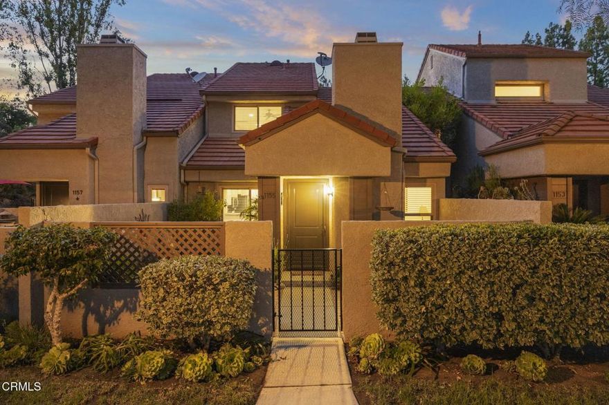 Welcome to the home you've been looking for. This 3 bedroom and 2 1/2 bath Hidden Canyon gem boasts an enviable private location with a breathtaking canyon view and the largest floorplan in the community. Once you enter through the private brick bordered front patio, complete with low maintenance landscaping, you'll be instantly welcomed into the large living area, with a cozy fireplace and mantle, warm rich wood flooring, and expansive ceilings. An adjacent space, currently used for media, is a perfect spot for an office or lounge area.The easy flow continues into the kitchen with an expansive amount of cabinetry, custom granite counters with tile backsplash, an oversized sink, and stainless appliances. The bar counter area offers an additional space to entertain while cooking. A large dining room offers opportunity for fantastic meals and conversations, with inviting overhead lighting. Next to the kitchen and dining room, you'll find a second private atrium patio with warm Saltillo tiles, making this a creative space for various opportunities such as reading, relaxing, or dining al fresco. Downstairs, the powder bath has been remodeled with a modern custom vanity and sink, as well as extra storage. As you make your way up the stairs, the second floor of the home offers plush new carpet and baseboards, and fresh paint throughout. The primary suite affords a comfortable space with two closets, mountain views and a ceiling fan. Additionally, the room flows seamlessly into a primary bath sanctuary, which has been remodeled with a warm wood vanity, LED lighted mirror, tile floors, and a large custom tiled shower. The hallway bath has also been tastefully remodeled with warm finishes and classic touches, with a new vanity and custom tiled shower and tub combo. Two additional and spacious bedrooms upstairs offer mirrored closet doors and ceiling fans.  Privacy, views, and thoughtfully considered updates make this home a warm and comfortable place you'll be thrilled to call home. The Hidden Canyon community offers fantastic amenities, including three sparkling pools, relaxing spas, a playground, lush green spaces perfect for pets, and scenic breathtaking mountain views. The community is conveniently close to top-rated schools, scenic hiking and biking trails, the YMCA, and Westlake Village's best shopping and dining spots.