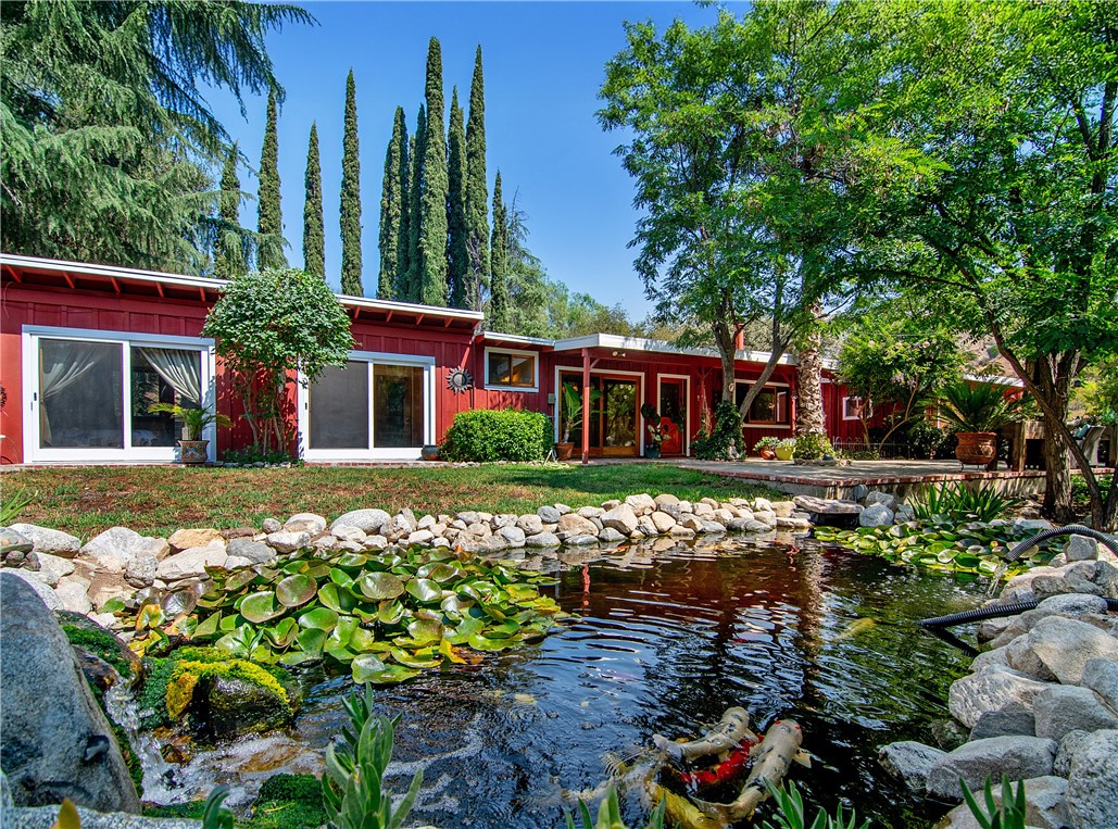 Welcome to Riverwood Ranch, a private gated ranch community in NE Los Angeles. This 3-acre horse property sits on the edge of the breathtaking Angeles National Forest, a serene retreat offering the perfect balance of rustic charm and modern comfort, just minutes from the city yet worlds away.
Whether you’re a horse enthusiast, a creative soul looking for space and inspiration, a nature lover, or simply someone who craves privacy and peace – this is a property that speaks for itself. The charming main residence offers cozy living with a high efficiency wood burning fireplace for winter nights, 3 bedrooms with 1 being an en-suite plus 1 more bathroom. Newer roof, HVAC, electrical and interior paint. Infrastructure to add solar. Fire suppression system. The property is dotted with mature oaks, pine, eucalyptus, cotton wood, pepper trees, native landscaping, and open skies that make every sunrise and sunset unforgettable. 7 citrus trees, blackberries, strawberries, pomegranate, plum and fruit bearing olive trees for the gardener – complete with a greenhouse with water and electricity plus a chicken coop. Magical golden hours when the hills light up with the setting sun, leading to an evening of relaxing in the jacuzzi and infrared & steam sauna, overlooking the babbling Koi pond. For the equestrian, currently house 4 horses with the possibility of 6-8 more near the 60 foot round pen, direct access to hundreds of miles of trails in Angeles National Forest for beginner to advanced riders: Fascination Springs Trail, Doc Larsen Trail, Eby Canyon (Pipeline)Trail, Rattlesnake Trail. Saddle up and ride! Peaceful. Secluded. Inspiring. Properties like this rarely come available—don’t miss the opportunity to own a piece of California’s hidden ranch community, just beyond the city limits. Getaway to the mountains yet just 20-30 minutes to Burbank, Glendale, Pasadena and DTLA.