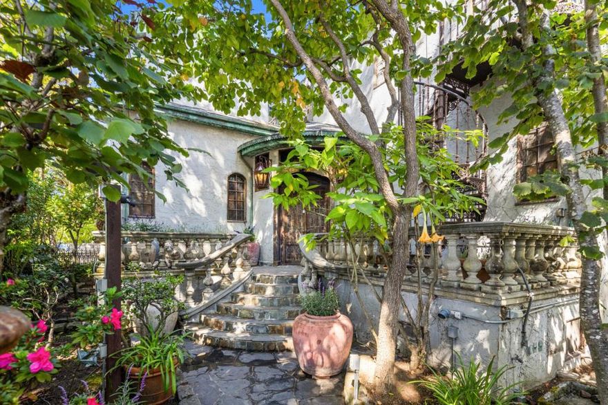 Celebrated for its architectural significance, this extraordinary home was featured in Architectural Digest in 1992.  The home was rebuilt during the late 1980s into an Old World European country house. Its turreted foyer, hand -plastered walls, arched windows, and rustic beams evoke the romance of Southern France and Italy. Featuring soaring living room with a limestone fireplace, formal dining room and an old fashioned kitchen with hand-hewn cabinetry, concrete counters and leaded-glass windows. The top floor is devoted to a spacious primary suite with fireplace, private balcony and luxurious bath. Adjacent to the bedroom is a family/media room beneath a lofty ceiling which could be used as a bedroom. The 2nd level offers a library adaptable as a third bedroom, an additional bedroom and a large bath. The lower level adds a bonus room with outside entrance and an adjoining bath.  The lushly landscaped grounds, arranged for privacy and anchored by a sparking flagstone-surrounded pool. A charming guest/pool house with full kitchen and bath enhances the accommodations, creating a true retreat just one block from Broadway; shops and cafes.