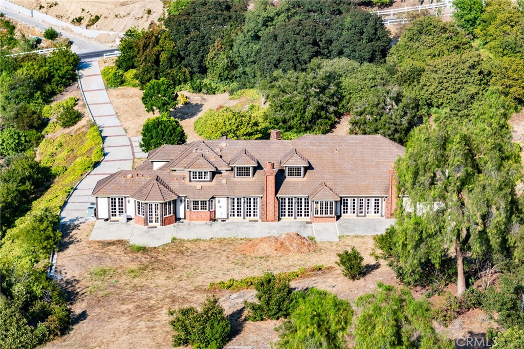 Welcome to this stunning French Country-style private estate located in one of Diamond Bar’s most exclusive guard-gated communities—The Country Estates. Nestled on a sprawling **2.18-acre lot**, this elegant residence offers exceptional privacy, expansive living space, and endless potential for expansion or custom development.
Featuring **5 spacious bedrooms and 6 luxurious bathrooms**, the home is thoughtfully designed with a blend of **hardwood flooring and plush carpeting**, a **butler’s pantry**, and an expansive **upstairs bonus room** complete with a **private office and dedicated workspace**. The **gourmet kitchen** is a chef’s dream, appointed with **Sub-Zero refrigeration**, premium **stainless steel appliances**, and a generous **wine bar**, perfect for entertaining.
The **open-concept layout** seamlessly connects the kitchen, breakfast room, and living areas to the **secluded backyard**, ideal for hosting guests or enjoying peaceful evenings. The **primary suite** offers a retreat of its own, with **dual oversized walk-in closets** and serene hillside views. Additional highlights include a **sauna**, **massive attic storage**, and ample space to build a custom pool or guest house.
Enjoy **breathtaking panoramic views**, **top-rated schools in the award-winning Walnut Valley Unified School District**, and **convenient access to the 57 and 60 freeways**. Just minutes from **H-Mart, major shopping centers**, and a wide array of dining options, this property offers the perfect blend of luxury, comfort, and accessibility.
With its **boasting 2.18-acre lot**, this estate presents a **rare opportunity to expand, build, or simply enjoy the serene lifestyle** of Southern California living at its finest.